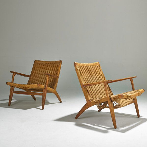 HANS WEGNER; CARL HANSEN AND SON: Pair of lounge chairs, Denmark, 1960s; Oak and woven seats and back; Foil label to one; Each: 28 1/2" x 27 1/2" x 29"