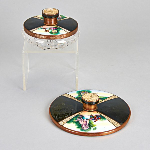 CONTINENTAL ENAMELED COPPER VANITY ITEMS: Covered pressed glass jar and hand mirror, each with scenic romantic reserves and black enameled quarters divided by craquelure egg shell inlay on copper; Mirror: 6 7/8", jar: 5 1/2" x 3 1/4"
