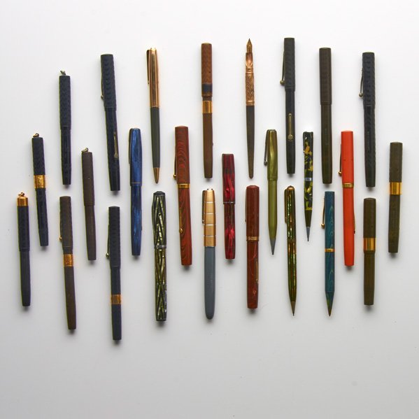WATERMAN FOUNTAIN PENS AND PENCILS: Twenty-six, late 19th-early 20th c.: Orange swirl hard rubber in original box; Ten brown or black hard rubber fountain pens, etc.; All marked; Longest: 5 1/2"