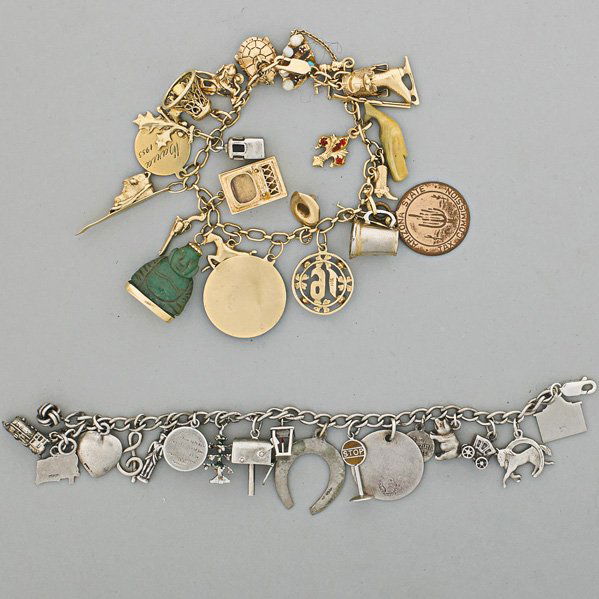 TWO CHARM BRACELETS, MID 20th C.: 14k gold chain suspends twenty-two gold, silver or other charms; Sterling bracelet suspends seventeen silver charms; 64.5 dwt
