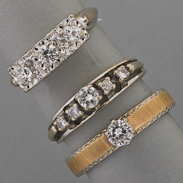 THREE DIAMOND RINGS, 1940-1960: Three-stone in 14k wg.; Five-stone in 14k wg.; Solitaire 14k yg.; Diamonds approx. 1.10 cts. TW; 6.3 dwt., sizes 6, 8, 9