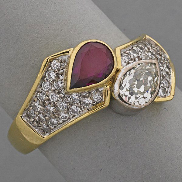 18K GOLD DIAMOND AND RUBY BYPASS RING, ca. 1980: Pear-shaped old mine cut diamond, approx. .45 ct. and ruby, approx. .50 ct. with diamond pave, approx. .70 ct. TW in 18k yg.; 4.4 dwt., size 8 1/2