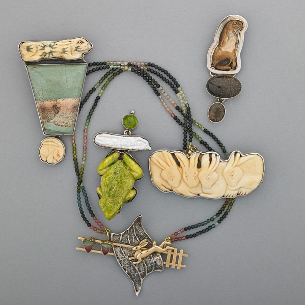 FIGURAL IVORY OR HARDSTONE CRAFT AMERICAN JEWELRY: Five pieces, ca. 1980-1990: Four Amy Kahn Russell silver pendant/brooches includes three with carved ivory rabbits, one carved and dyed ivory frog with river pearl and peridot, longest, 3"; Susan Gall