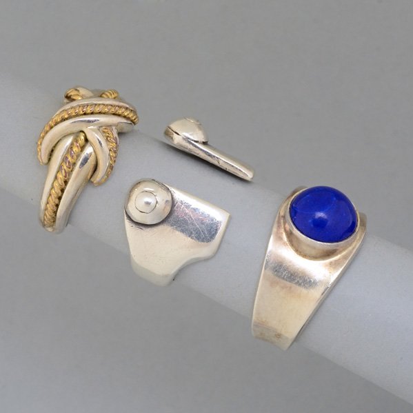 THREE FASHIONABLE SILVER RINGS: Georg Jensen, Denmark, #124 with lapis; Tiffany & Co. with 18k gold "X"; Modernist band, unsigned