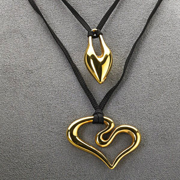 TWO 14K GOLD PENDANTS BY ROBERT LEE MORRIS: Hollow modern forms on black ribbon: Heart 1 7/8"; Drop-form 1 1/2"; 4.2 dwt. (6.5 gs.)