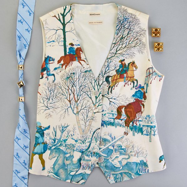 HERMES LADIES SILK VEST AND MEDOR JEWELRY: Ladies Hermes scarf silk vest, size 38, made in France, equestrian motif, mother-of-pearl buttons, adjustable elastic belt back, 20"; Hermes Twilly Medor scarf in blue-on-blue equestrian silk with gol
