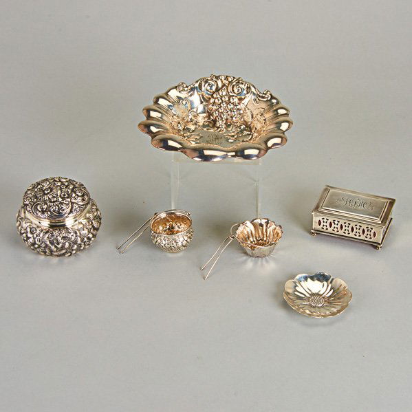 AMERICAN AND FOREIGN SILVER ORNAMENTAL ACCESSORIES: Six pieces, 19th and 20th C.: Redlich floral repoussé dresser box; Repoussé tea strainer; Gorham floriform tea strainer on similar Peruvian silver dish; Redlich grapevine shell-shaped dish; F. Whiti
