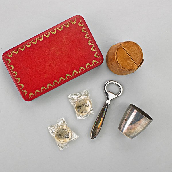TIFFANY & CO. AND CARTIER STERLING BAR ACCESSORIES: Set of four nesting cups in case by Tiffany & Co., 1912-1946, with leather case (as found), 5.35 OT; Cartier/Perrier hostess set, ca. 1979
