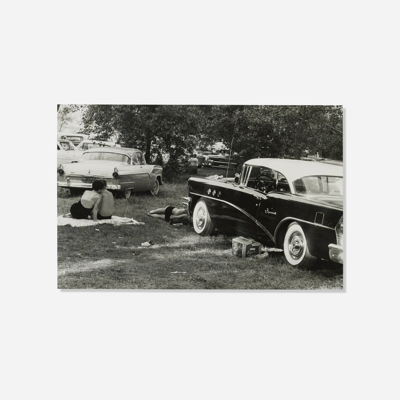 Robert Frank, Picnic in a Car Park, Fourth of July: Robert Frank Picnic in a Car Park, Fourth of July 1955 / printed 1979gelatin silver print image: 8.25 h x 13 w in (21 x 33 cm) sheet: 10 h x 14 w in (25 x 36 cm) Signed to verso 'R. Frank'.