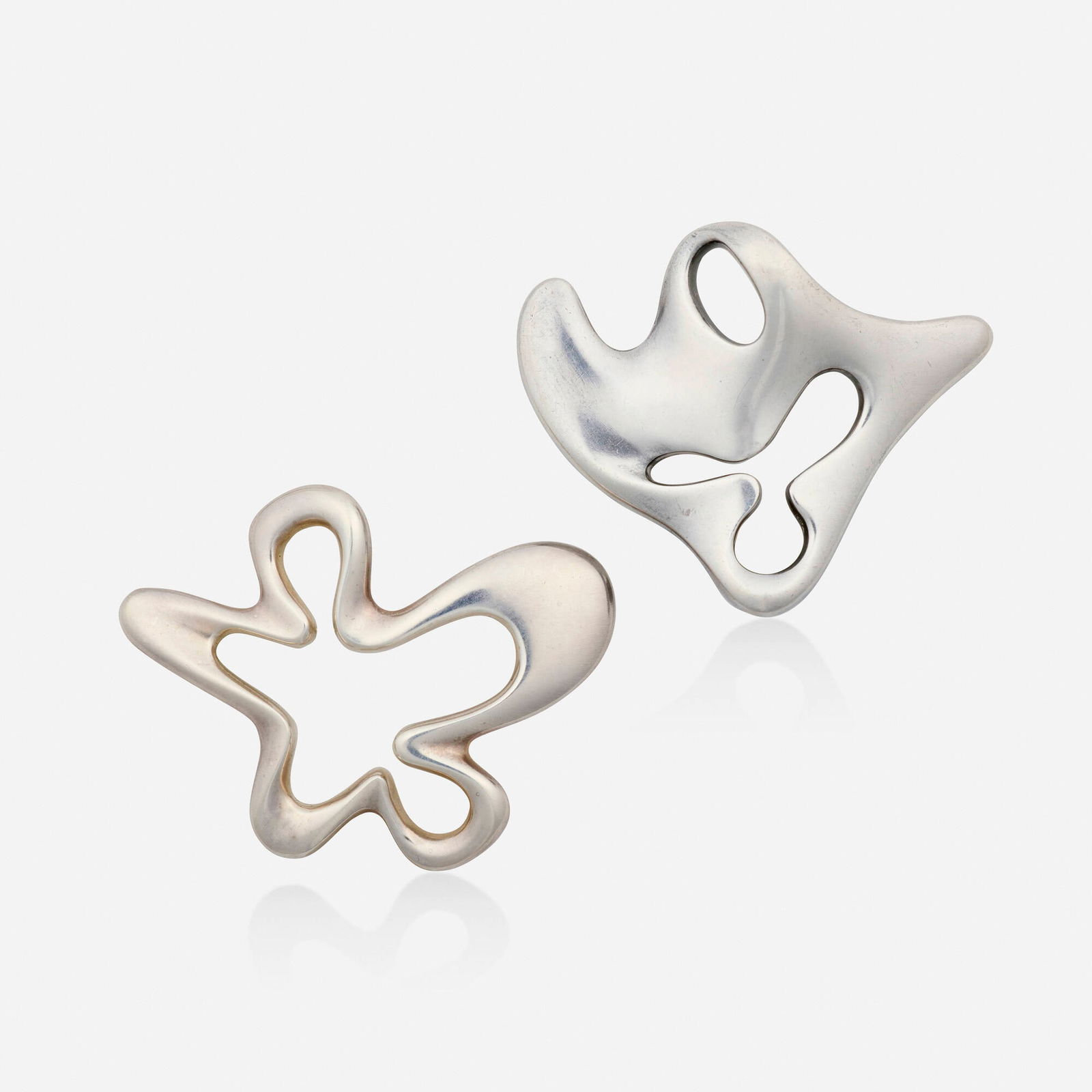 Henning Koppel for Georg Jensen, Two sterling silver 'Splash' and 'Amoeba' brooches: Henning Koppel for Georg Jensen Two sterling silver 'Splash' and 'Amoeba' brooches Each of open-form design, no. 321 and 322 Sterling silver Signed with maker's mark for Georg Jensen to each example