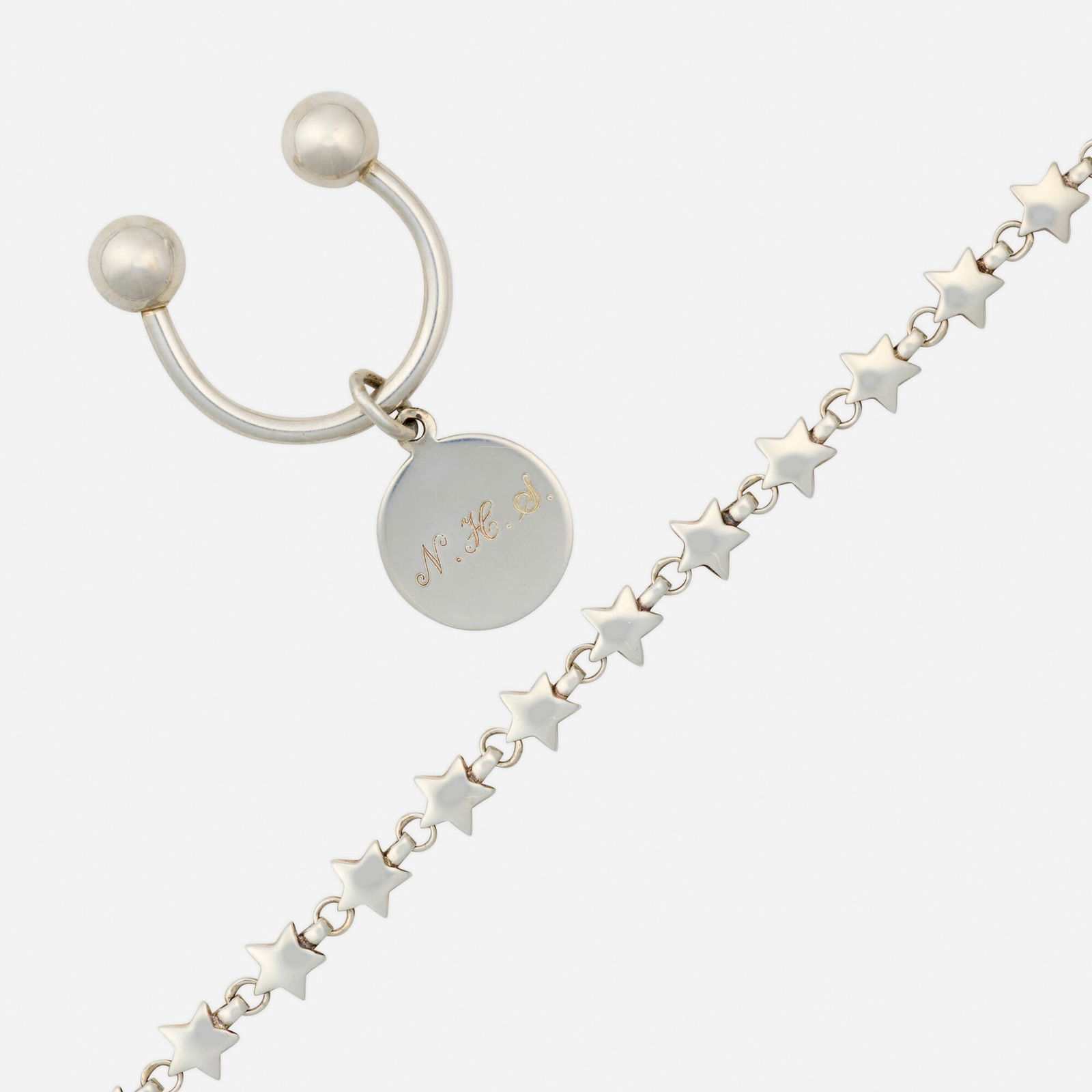 Tiffany & Co., Sterling silver bracelet and key chain: Tiffany & Co. Sterling silver bracelet and key chain The bracelet a line of stars, the key chain with personal monogram Sterling silver Signed T&Co. to bracelet, Tiffany & Co. to key chain Br