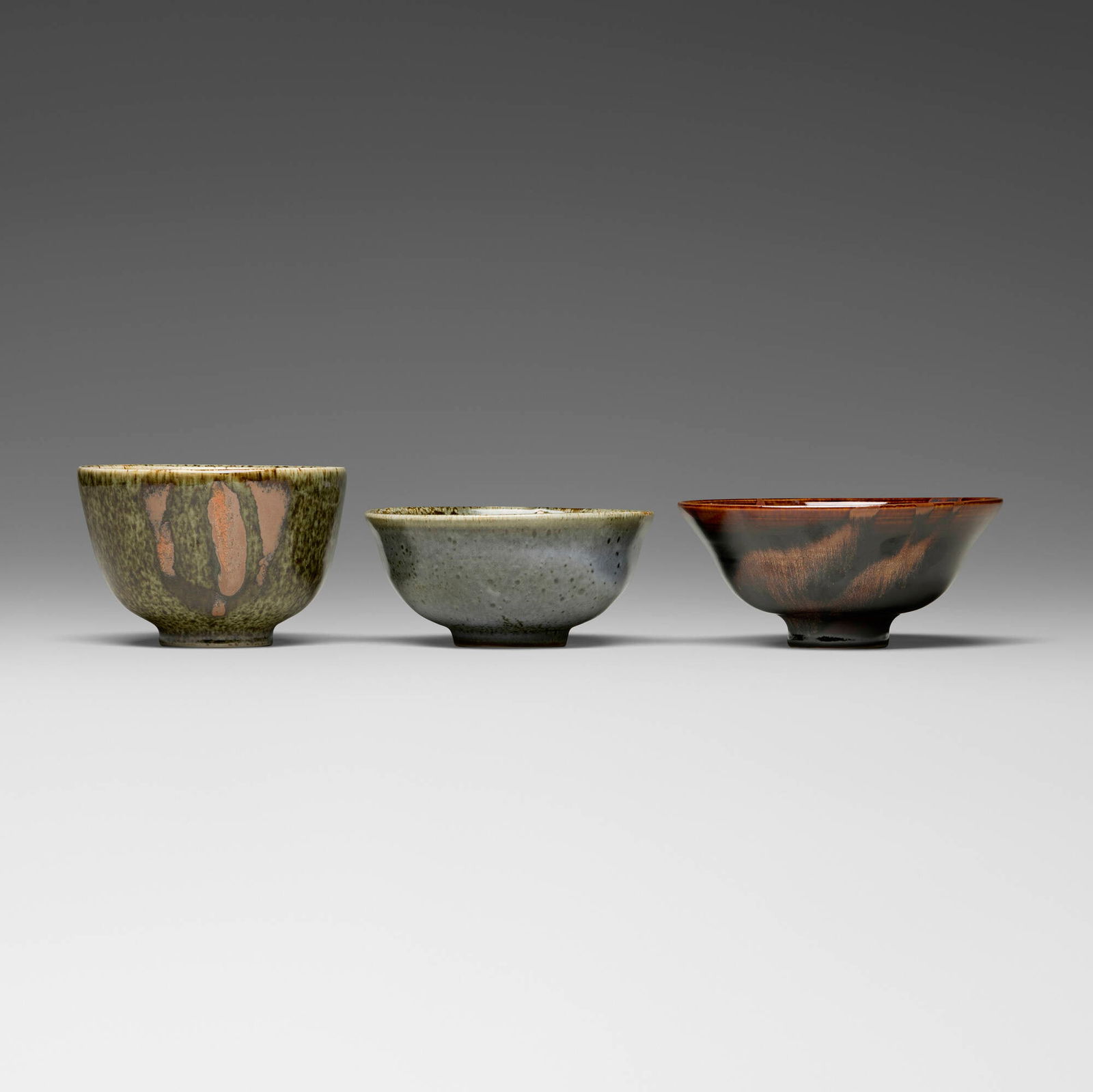 Brother Thomas Bezanson, Tea bowls, set of three: Brother Thomas Bezanson Tea bowls, set of three after 1985tenmoku-glazed porcelain, tea dust glazed porcelain, Choy celadon glazed porcelain 3.625 h x 5.75 dia in (9 x 15 cm) 2.875 h x 6.625 dia i