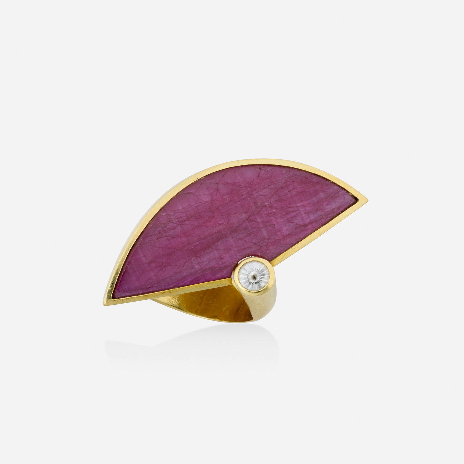 Atelier Munsteiner, Ruby, diamond, and gold ring: Atelier Munsteiner Ruby, diamond, and gold ring Set with a fancy-cut ruby and diamond 18k yellow gold Signed with maker's mark for Atelier Munsteiner Ring size 7; Gross weight 13.2 dwts