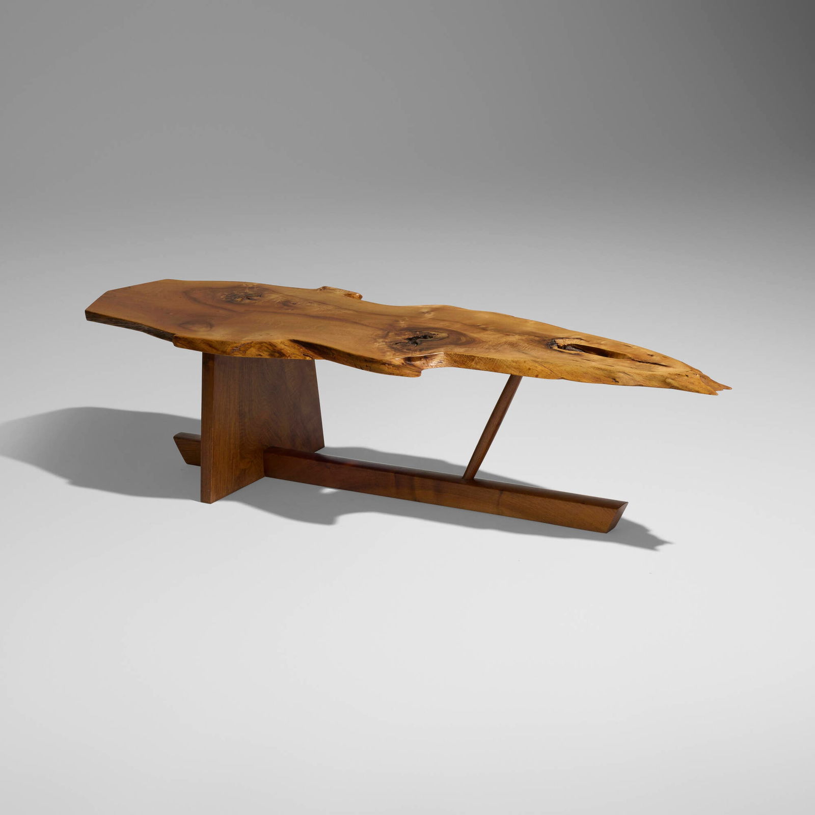 George Nakashima, Exceptional Minguren II coffee table: George Nakashima Exceptional Minguren II coffee table Nakashima StudioUSA, 1973English walnut, American black walnut 15 h x 61.75 w x 20 d in (38 x 157 x 51 cm) Table features a single s