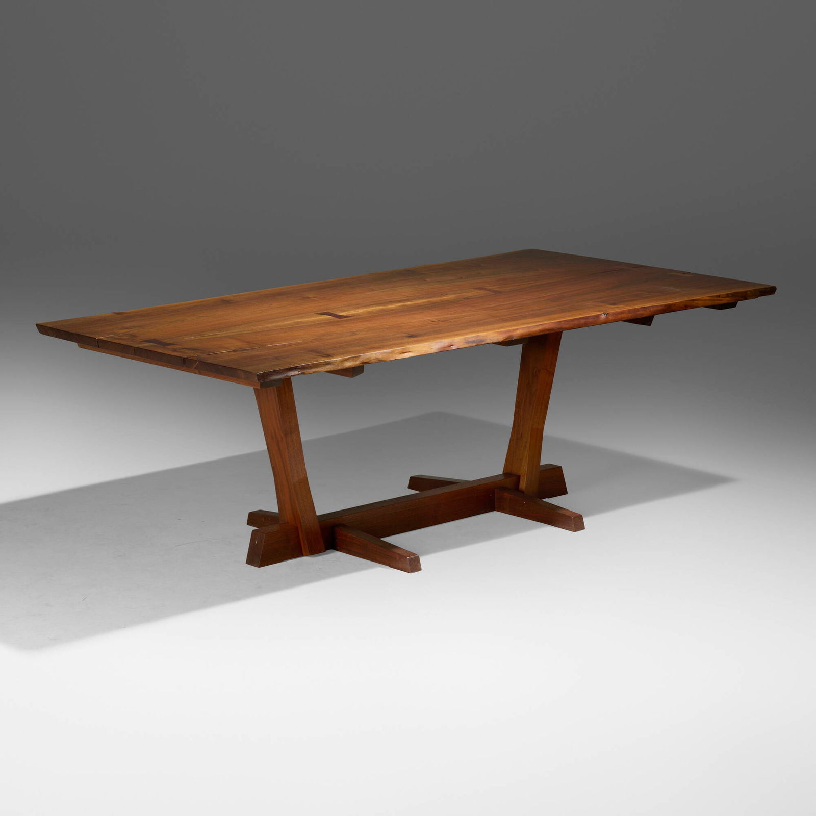 Mira Nakashima, Exceptional special-order Conoid dining table: Mira Nakashima Exceptional special-order Conoid dining table Nakashima StudioUSA, 2011Persian walnut, American black walnut rosewood 28.5 h x 83.75 w x 44.75 d in (72 x 213 x 114 cm) Tab