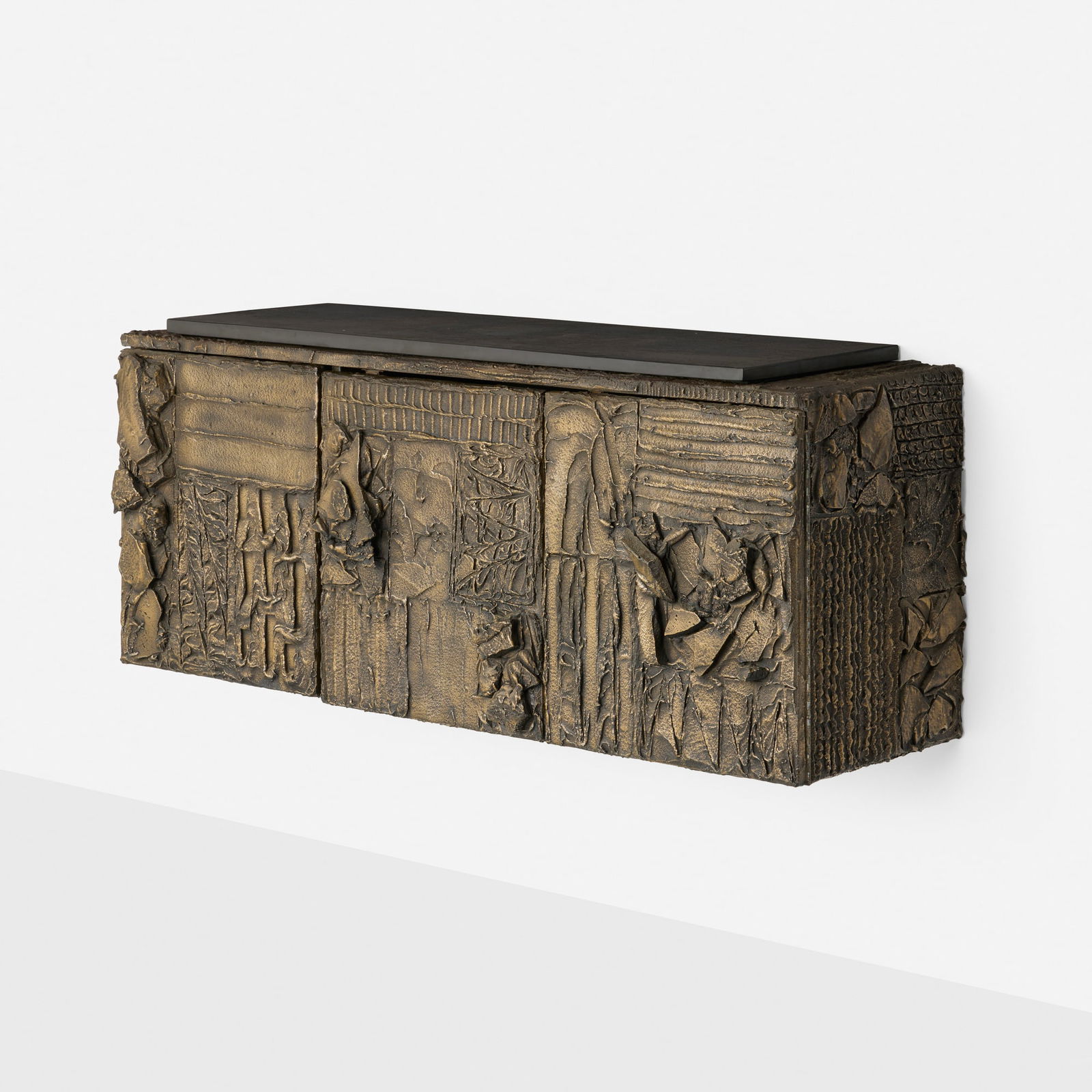 Paul Evans, Sculpted Bronze wall-hanging cabinet: Paul Evans Sculpted Bronze wall-hanging cabinet Paul Evans Studio for DirectionalUSA, 1968bronzed resin over wood, slate, lacquered wood, felt 23 h x 56.25 w x 18 d in (58 x 143 x 46 cm)
