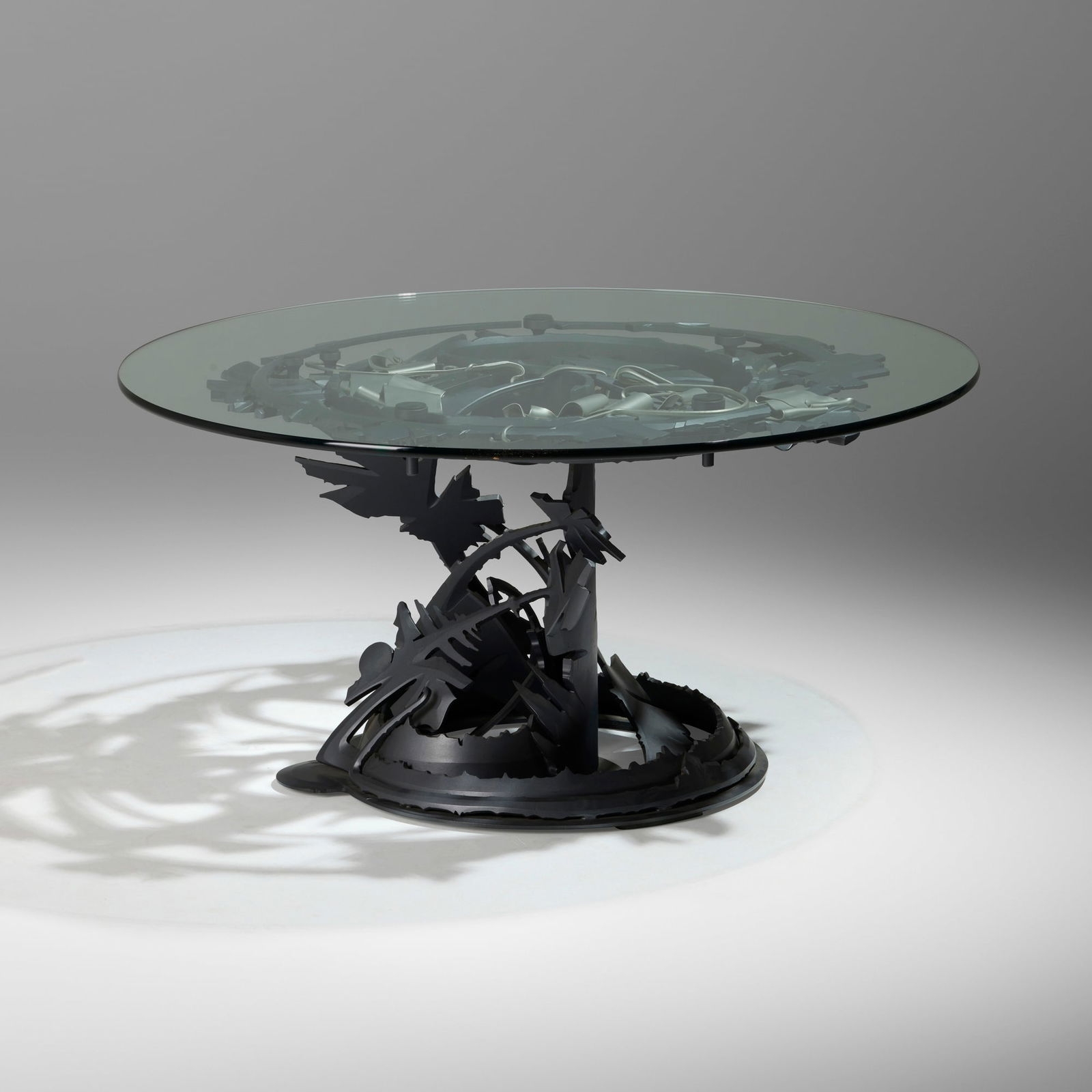 Albert Paley, Dragon's Back dining table: Albert Paley Dragon's Back dining table USA, 1998formed and fabricated steel with a polychromed finish, glass 30 h x 60 dia in (76 x 152 cm) Impressed signature and date to base '? Albert Pale