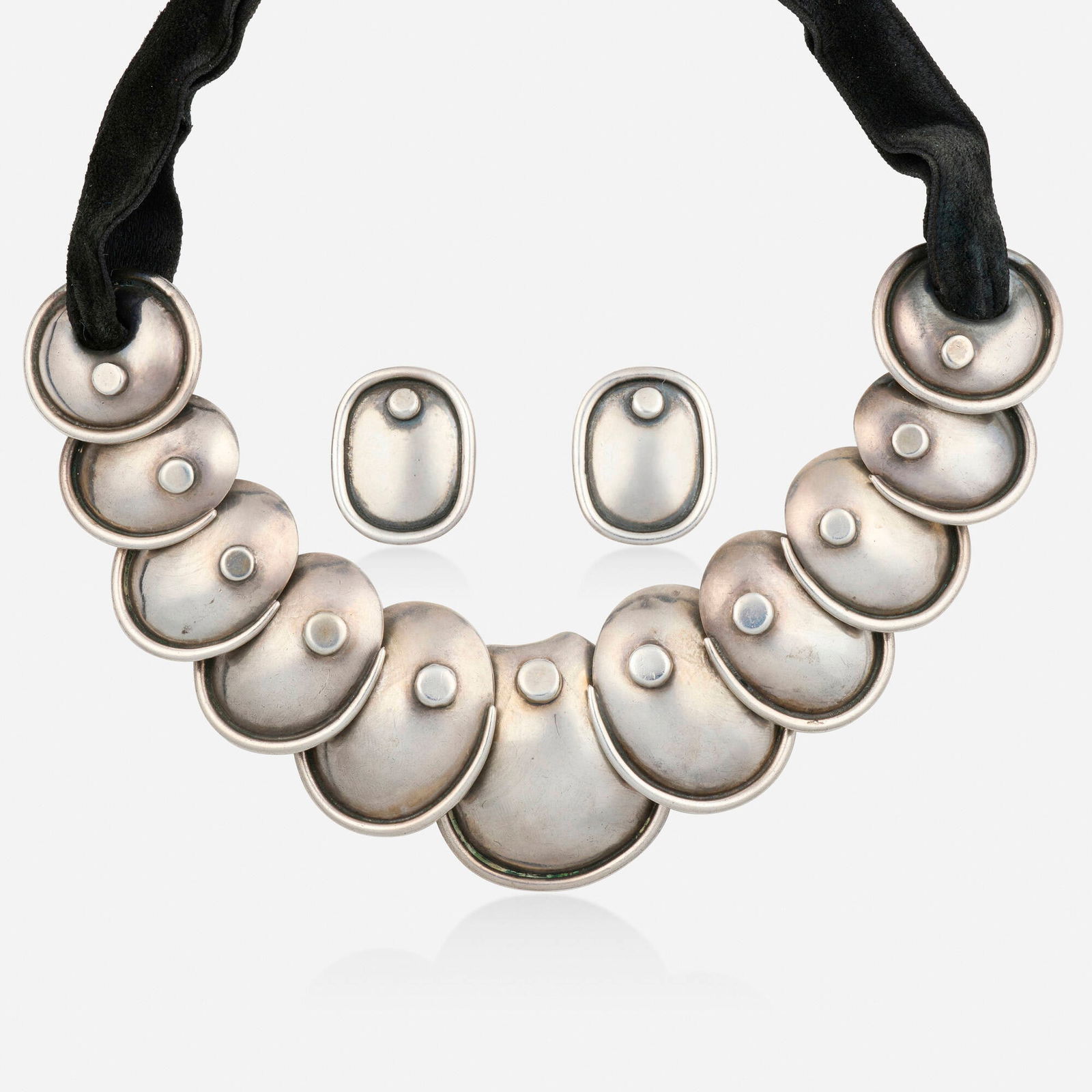 Hector Aguilar, 'Armadillo' silver necklace and earrings: Hector Aguilar 'Armadillo' silver necklace and earrings The necklace of graduated discs joined by velvet ribbon, the earrings similar; 1943-1948 Silver and base metal Signed with maker's mark for Hect