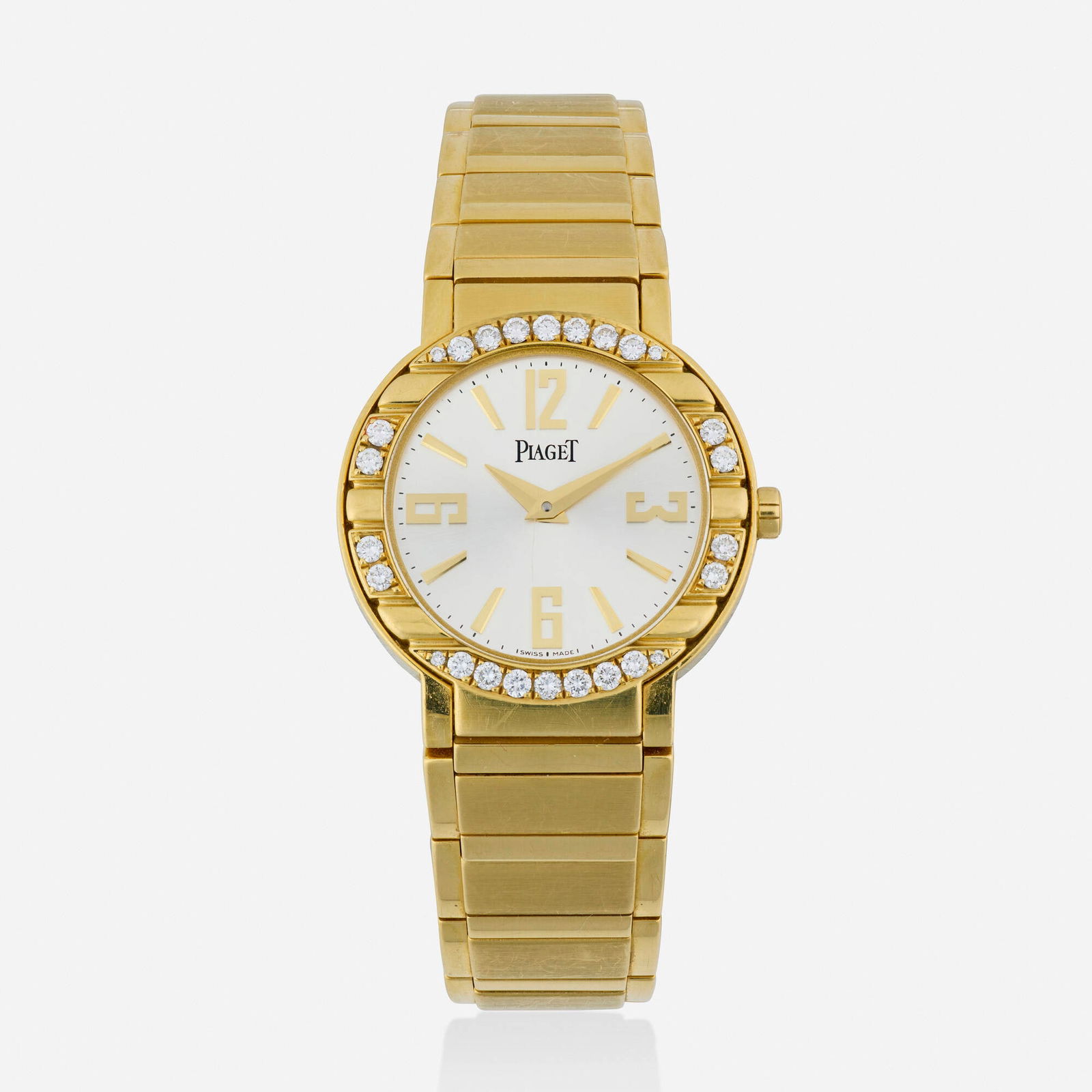 Piaget, 'Polo' diamond and gold wristwatch: Piaget 'Polo' diamond and gold wristwatch With Arabic and baton hours, the case set with round brilliant-cut diamonds Dial: Silvered Movement: Quartz Case material: 18k yellow gold