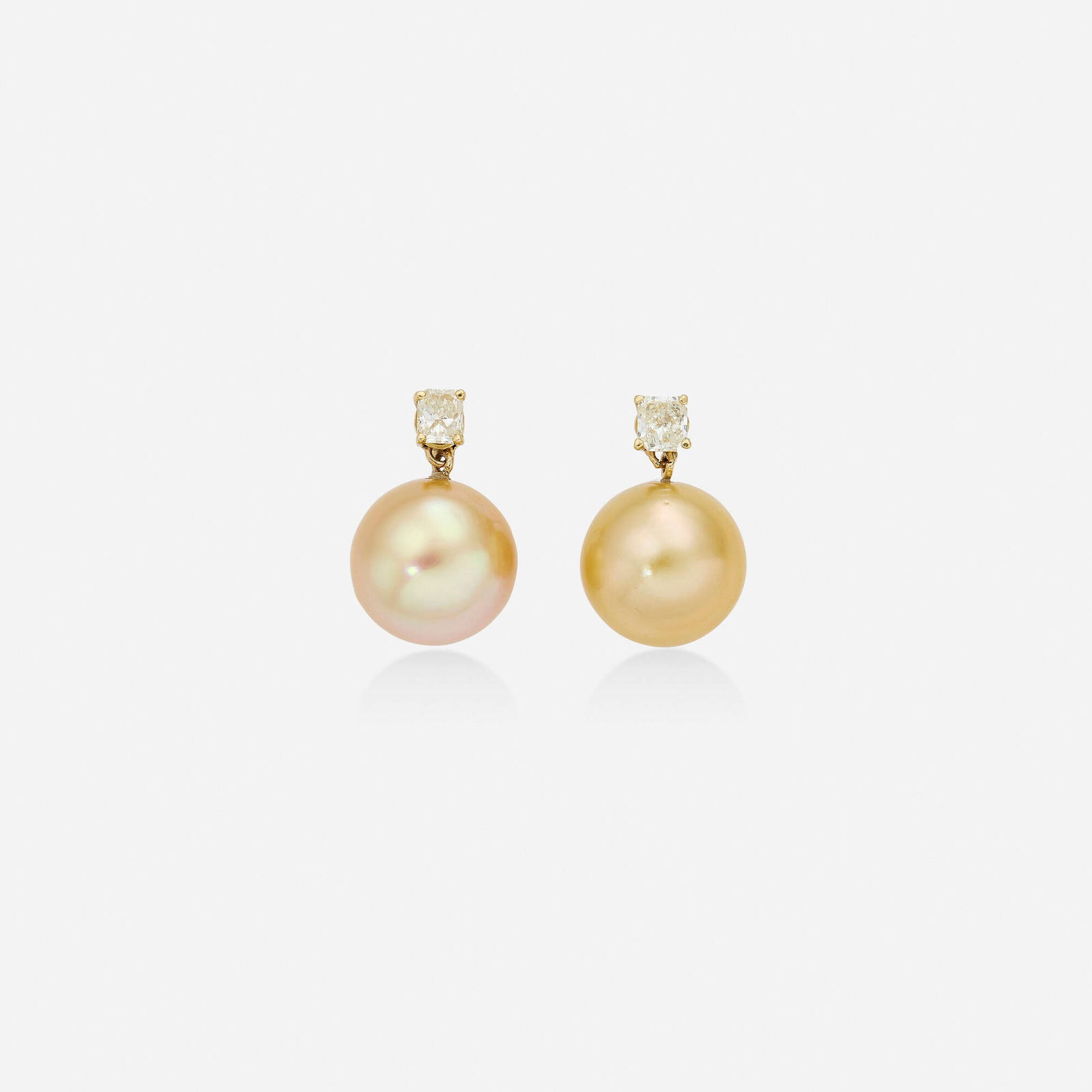 Cultured pearl, diamond, and gold earrings: Cultured pearl, diamond, and gold earrings Each set with a radiant-cut diamond and a golden cultured pearl 18k yellow gold 0.75 x 0.50 in; Gross weight 6.1 dwts This work will ship from Lambertville,