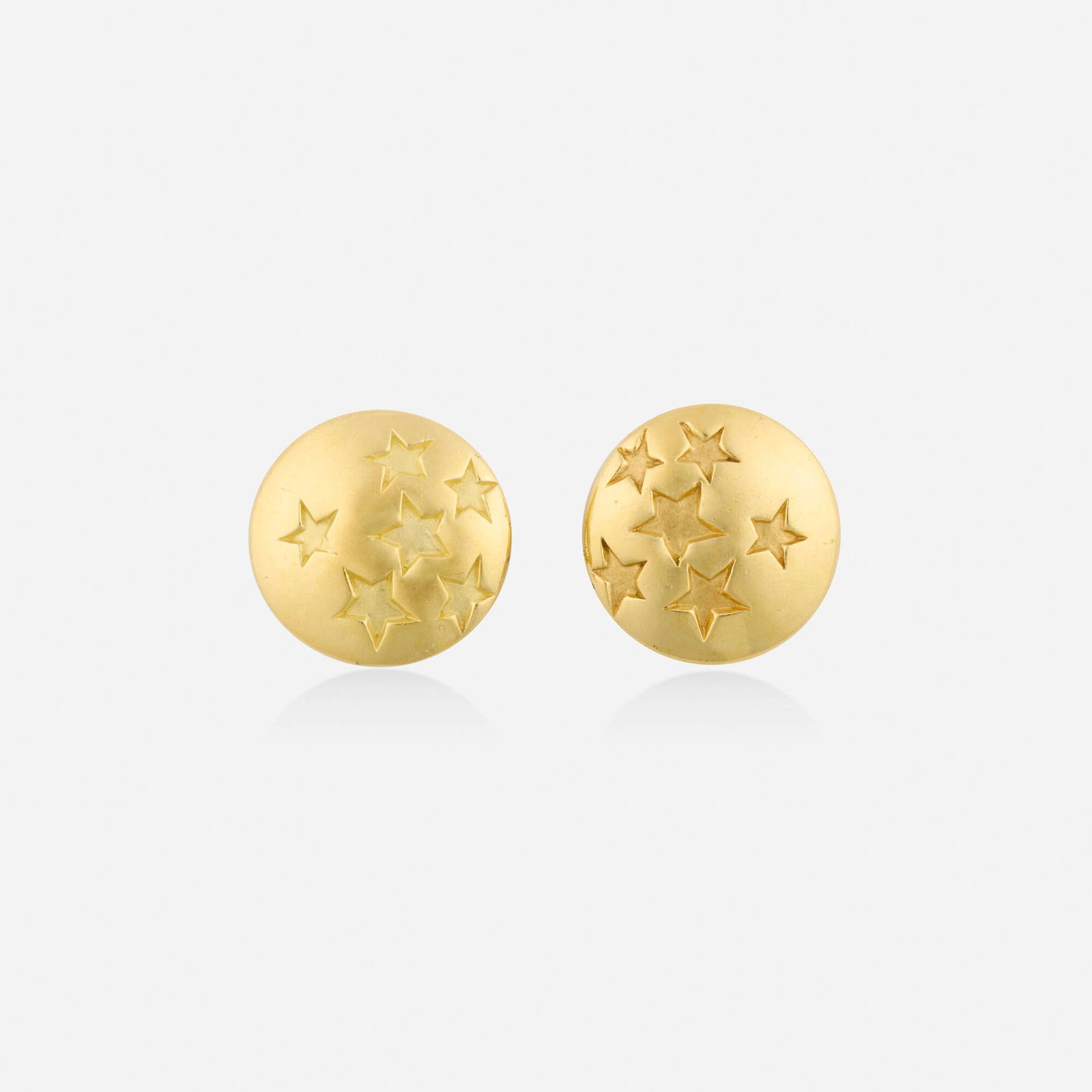 Angela Cummings, Gold earrings: Angela Cummings Gold earrings Each designed with impressed stars; 1986 18k yellow gold Signed Cummings 0.875 in; Gross weight 13.4 dwts This work will ship from Lambertville,