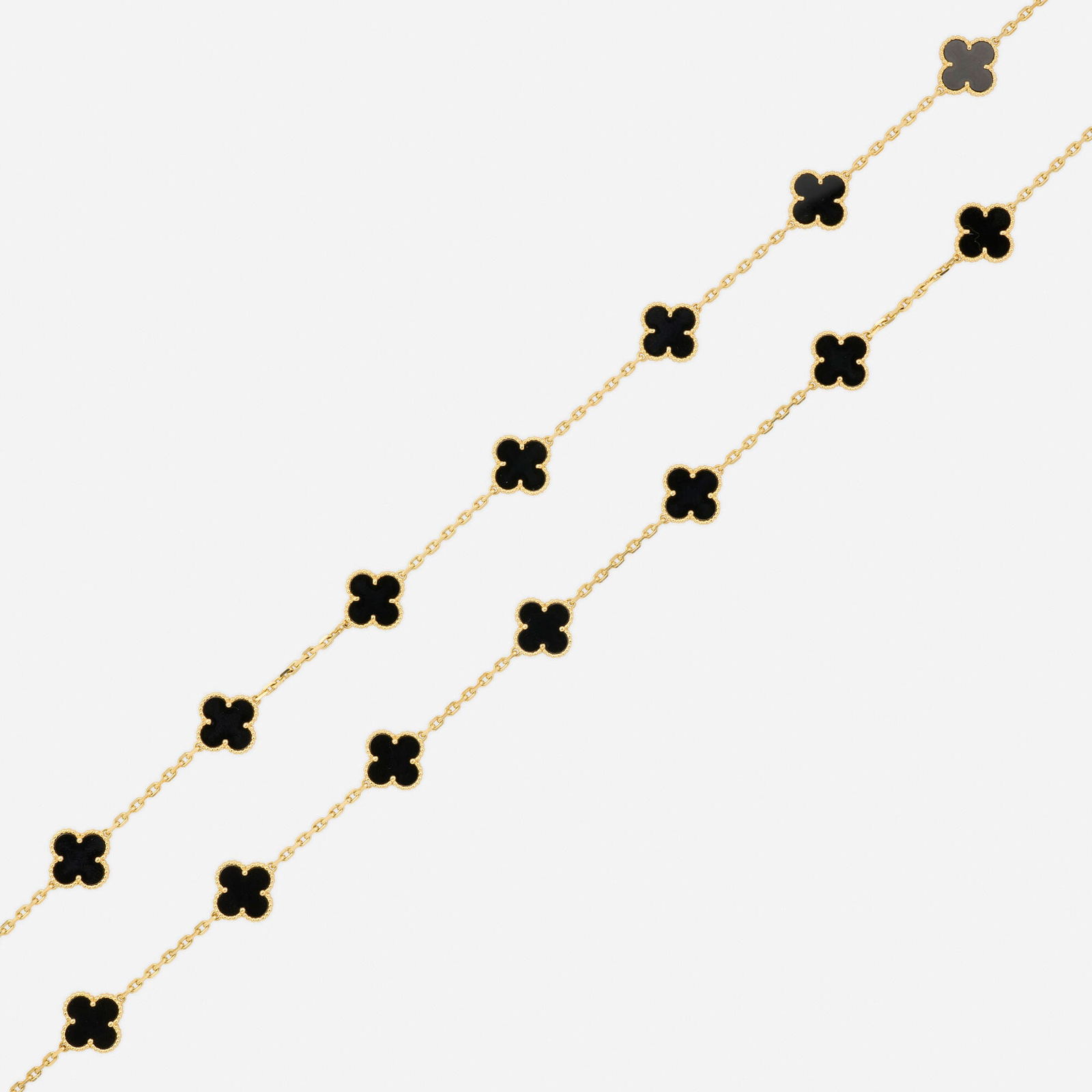 Van Cleef & Arpels, 'Alhambra' black onyx and gold necklace: Van Cleef & Arpels 'Alhambra' black onyx and gold necklace Of twenty black onyx 'Alhambra' stations 18k yellow gold Signed VCA, numbered 33.50 in; Gross weight 30.0 dwts Sold with signed pouch