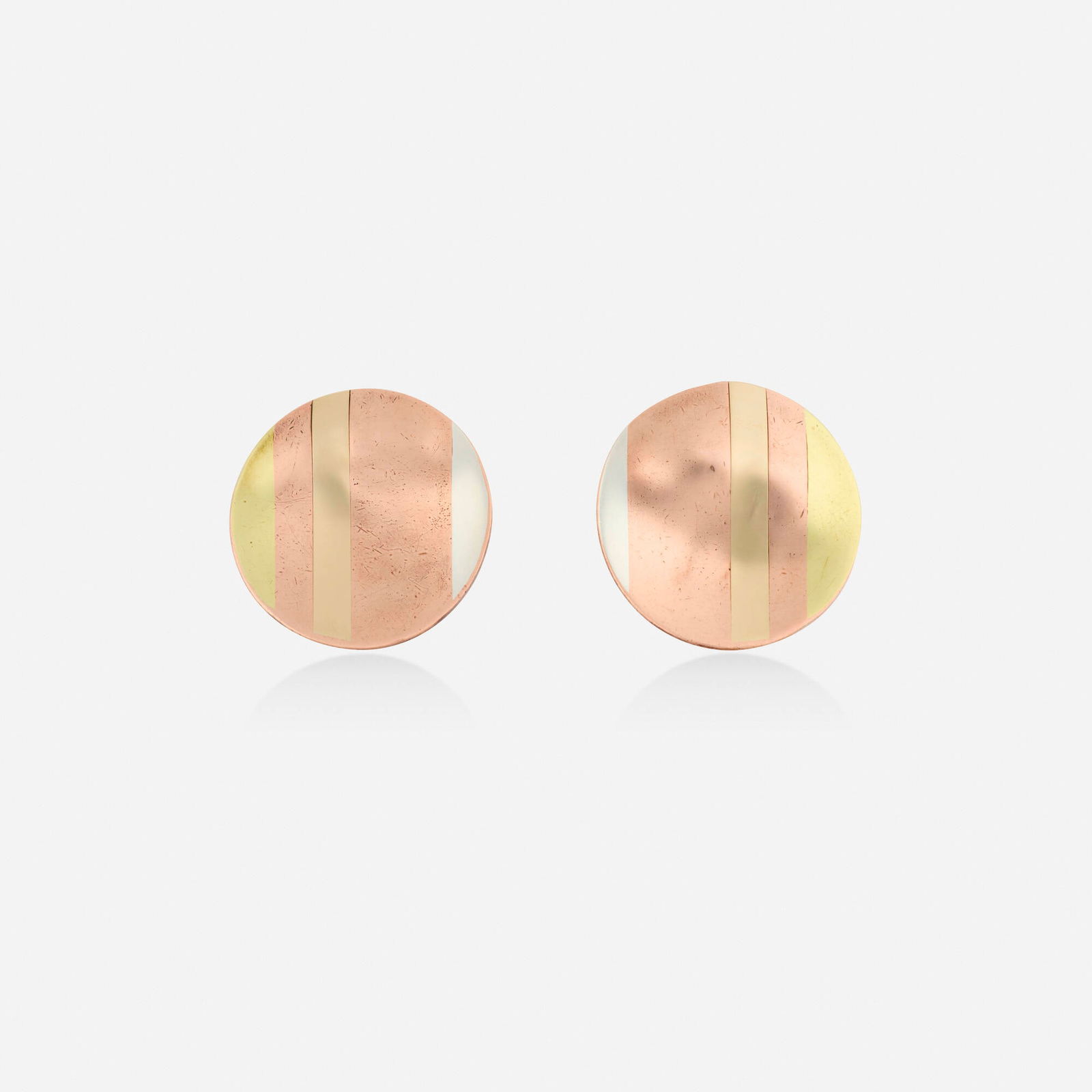 Angela Cummings for Tiffany & Co., 'Laser Lines' mixed metal earrings: Angela Cummings for Tiffany & Co. 'Laser Lines' mixed metal earrings Each disc inlaid with gold, silver, and copper Yellow gold, silver, and copper Signed Tiffany & Co. 1 in; Gross weight 5.6 dwts