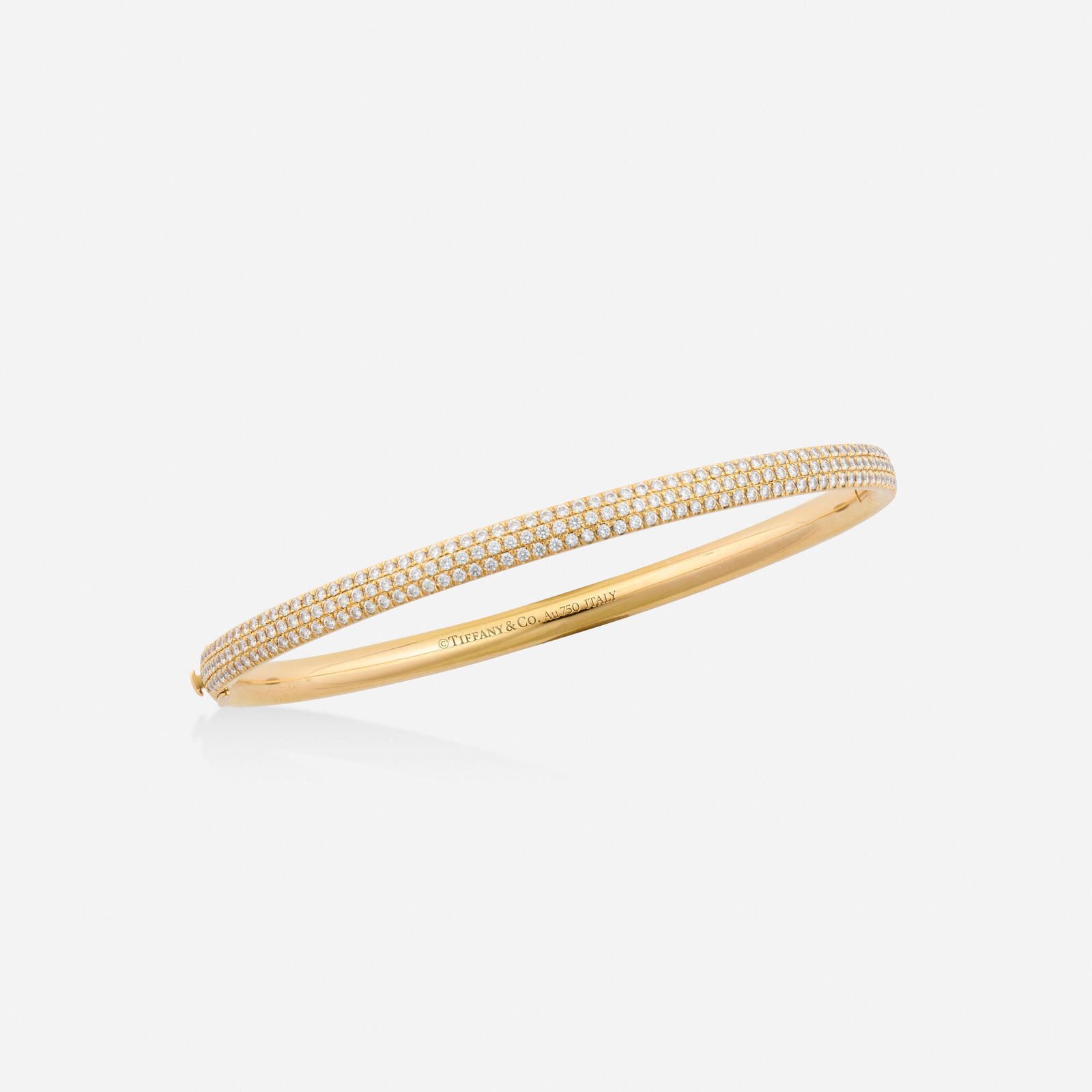 Tiffany & Co., 'Tiffany Metro' diamond and pink gold bracelet: Tiffany & Co. 'Tiffany Metro' diamond and pink gold bracelet The hinged bangle set with three rows of round brilliant-cut diamonds 18k pink gold Signed Tiffany & Co. Inner circ. 7 in, width 0.125-0.
