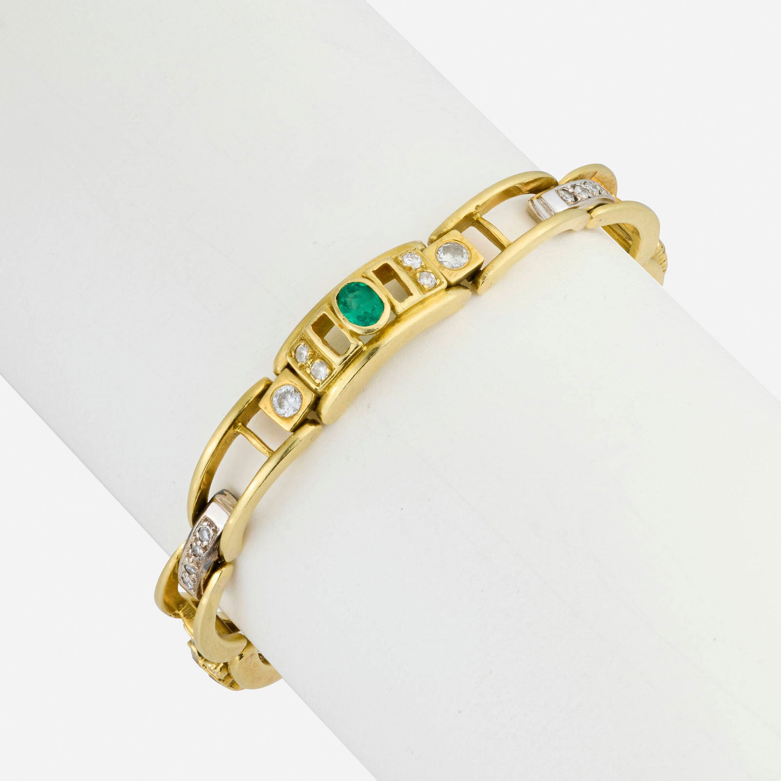 Emerald, diamond, and gold bracelet: Emerald, diamond, and gold bracelet Set with emerald and oval-cut emeralds, round brilliant and single-cut diamonds Yellow and white gold Inner circ. 6 in, width 0.25 in; Gross weight 16.0 dwts 