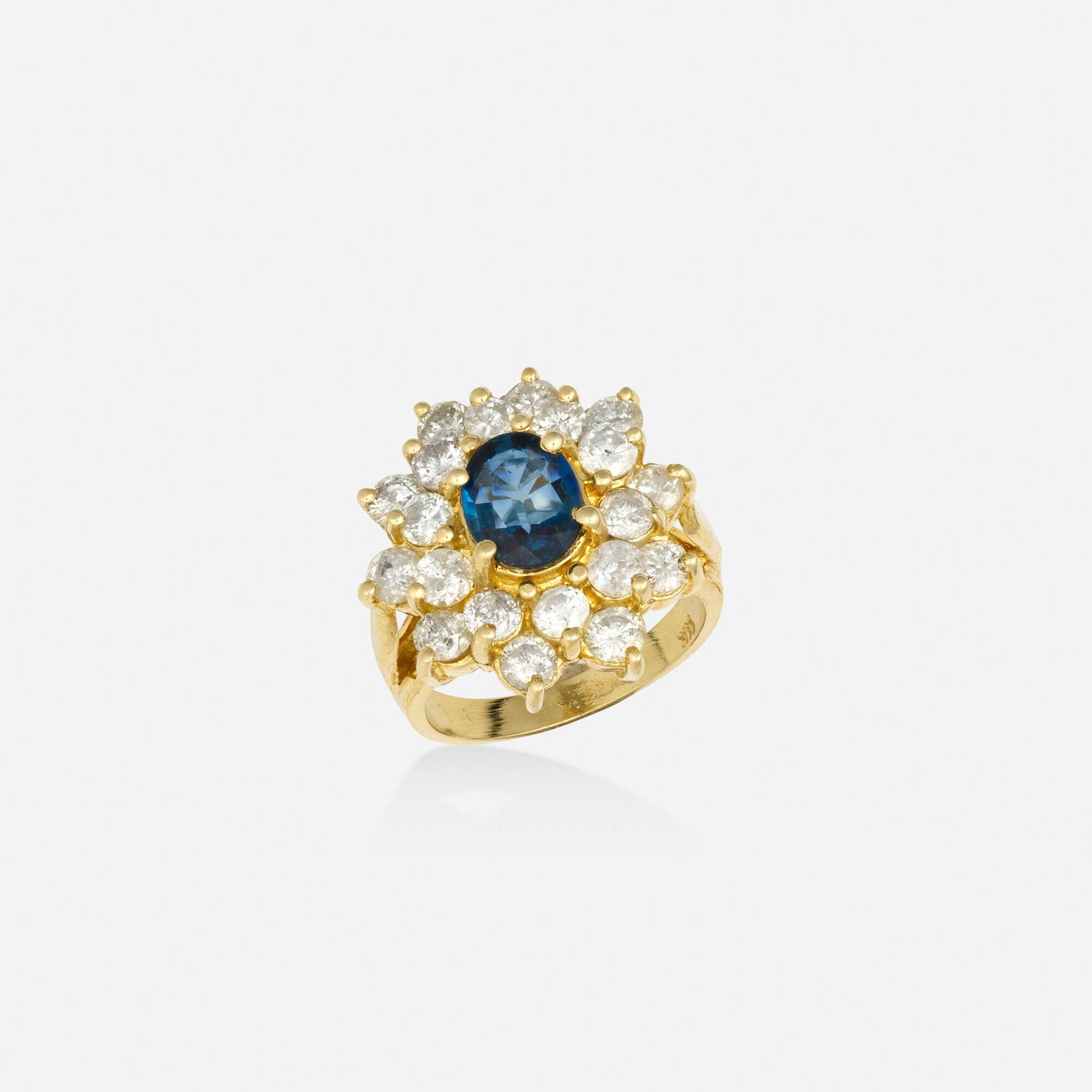 Sapphire, diamond, and gold ring: Sapphire, diamond, and gold ring Set with an oval-cut sapphire, surrounded by round brilliant-cut diamonds 14k yellow gold Ring size 6; Gross weight 5.2 dwts This work will ship from Lambertville, New