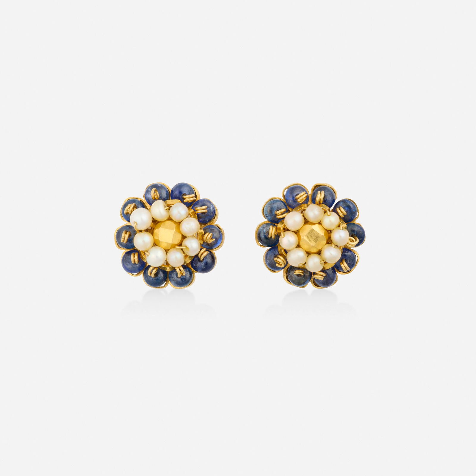 Sapphire, seed pearl, and gold earrings: Sapphire, seed pearl, and gold earrings Of floral design, set with sapphire and seed pearl beads 22k yellow gold 0.50 in; Gross weight 5.6 dwts This work will ship from Lambertville, New Jersey.