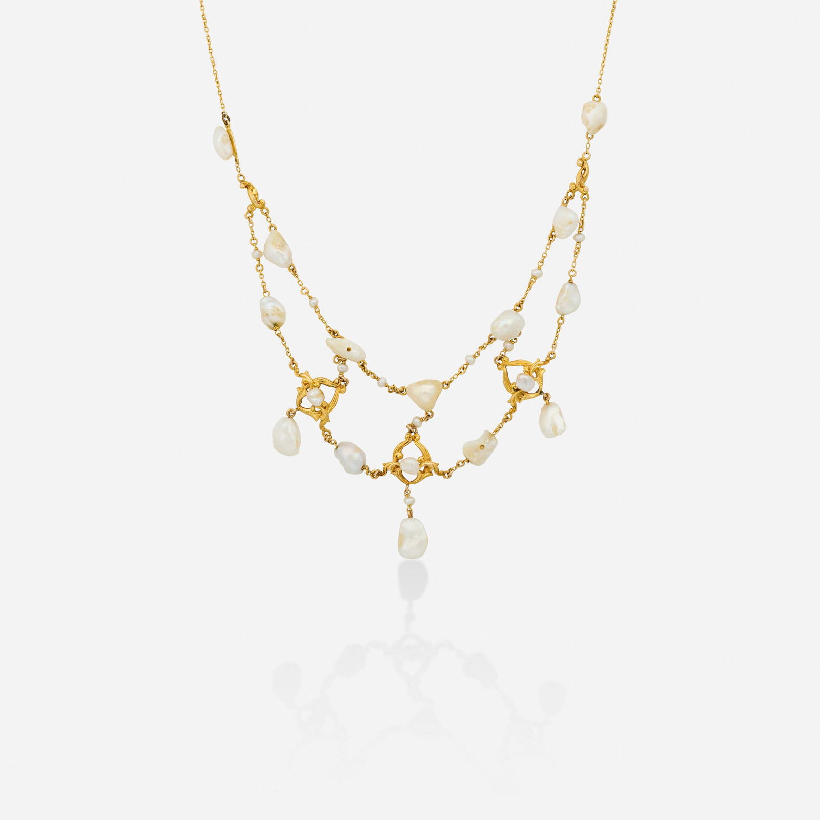 Freshwater cultured pearl and gold necklace: Freshwater cultured pearl and gold necklace Designed with swags of seed and freshwater cultured pearls Yellow gold 16.75 in; Gross weight 9.8 dwts This work will ship from Lambertville, New