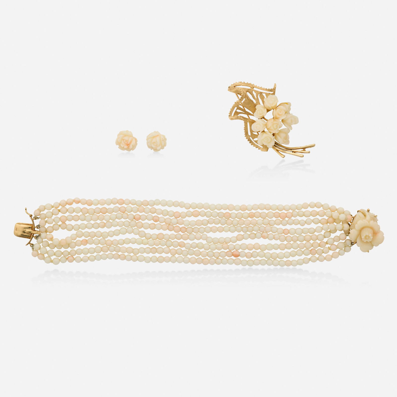 Group of coral and gold jewelry: Group of coral and gold jewelry Comprising a bracelet, brooch, and pair of earrings each set with carved coral roses Yellow gold Bracelet 8.50 x 1 in, brooch 2.50 x 1.50 in, earrings 0.50 in; Gross