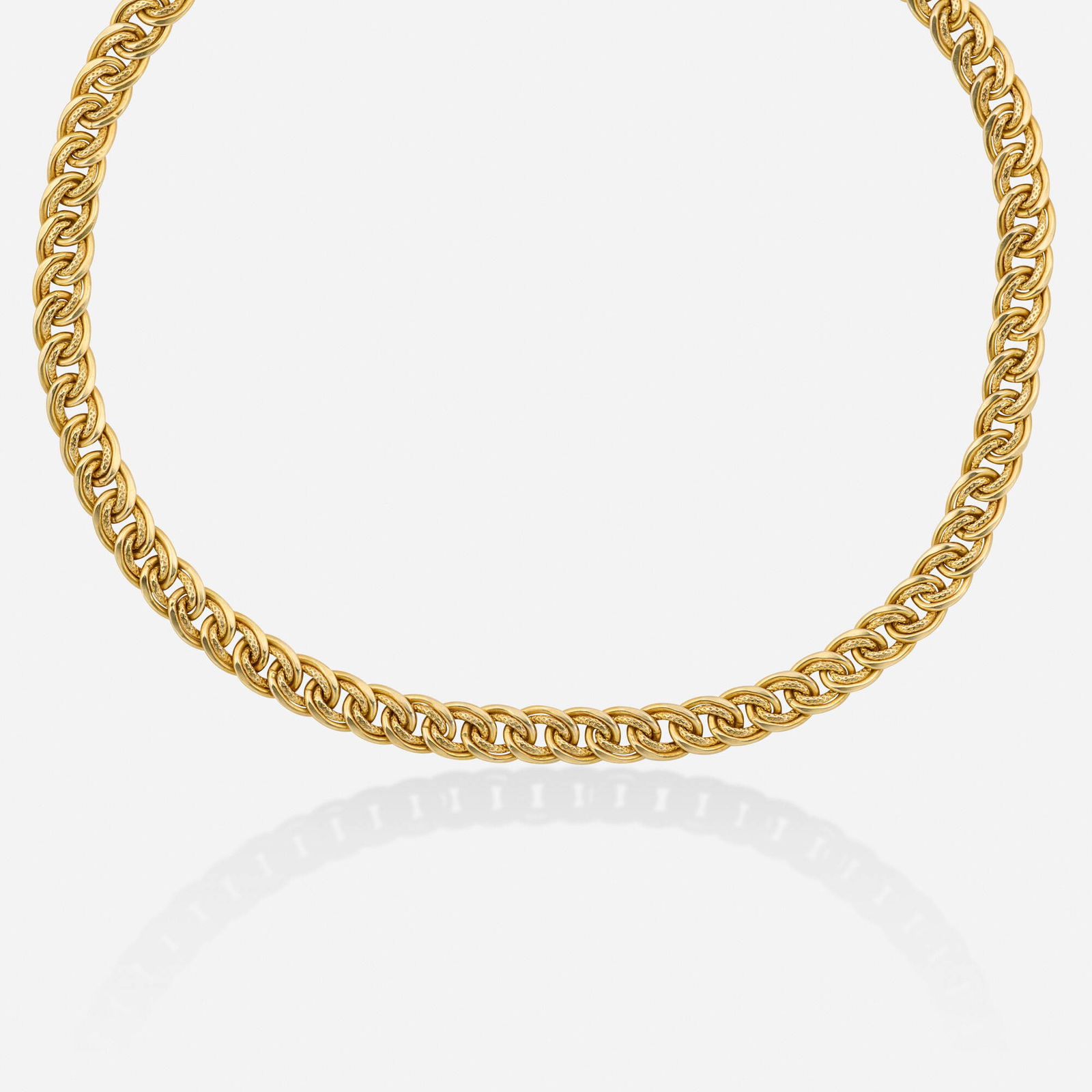 Gold and green chalcedony necklace: Gold and green chalcedony necklace Of polished and textured gold links, the clasp set with cabochon green chalcedony 14k yellow gold 17 in; Gross weight 13.6 dwts This work will ship from