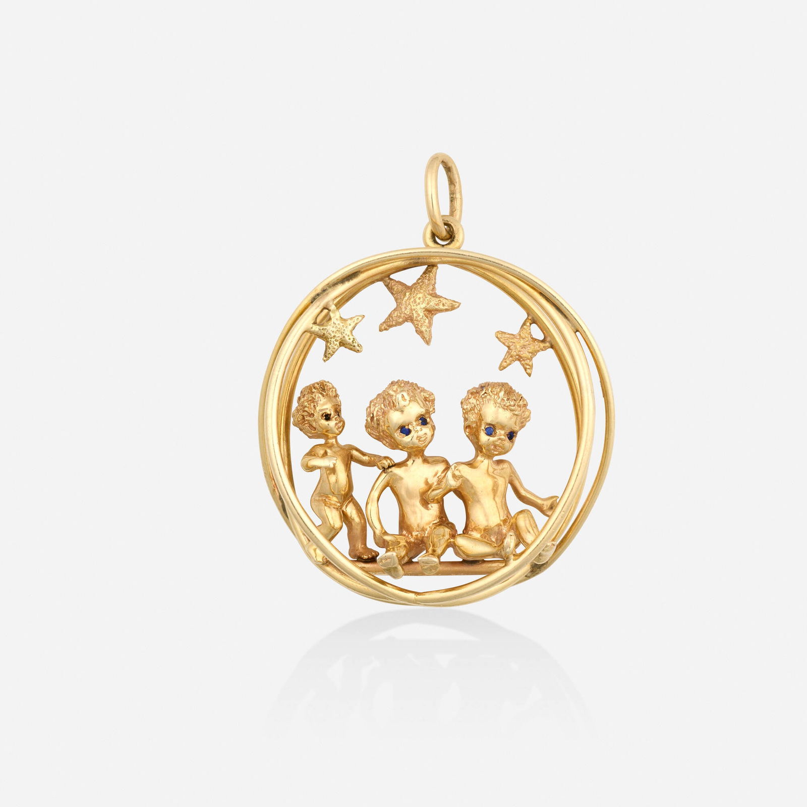 William Ruser, Gold and sapphire pendant: William Ruser Gold and sapphire pendant Designed with three stars and seated children, set with circular-cut sapphire eyes 14k yellow gold Signed Ruser 2 x 1.50 in; Gross weight 18.0 dwts This