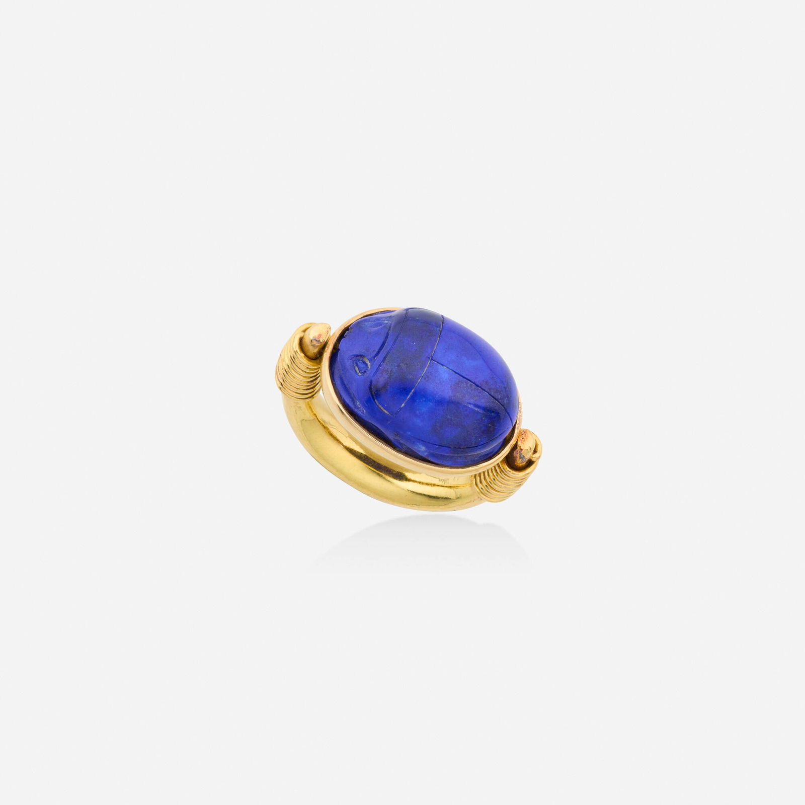 Lapis lazuli and gold ring: Lapis lazuli and gold ring Set with a carved lapis lazuli scarab Yellow gold Ring size approx. 5.50-6; Gross weight 11.5 dwts This work will ship from Lambertville, New Jersey.