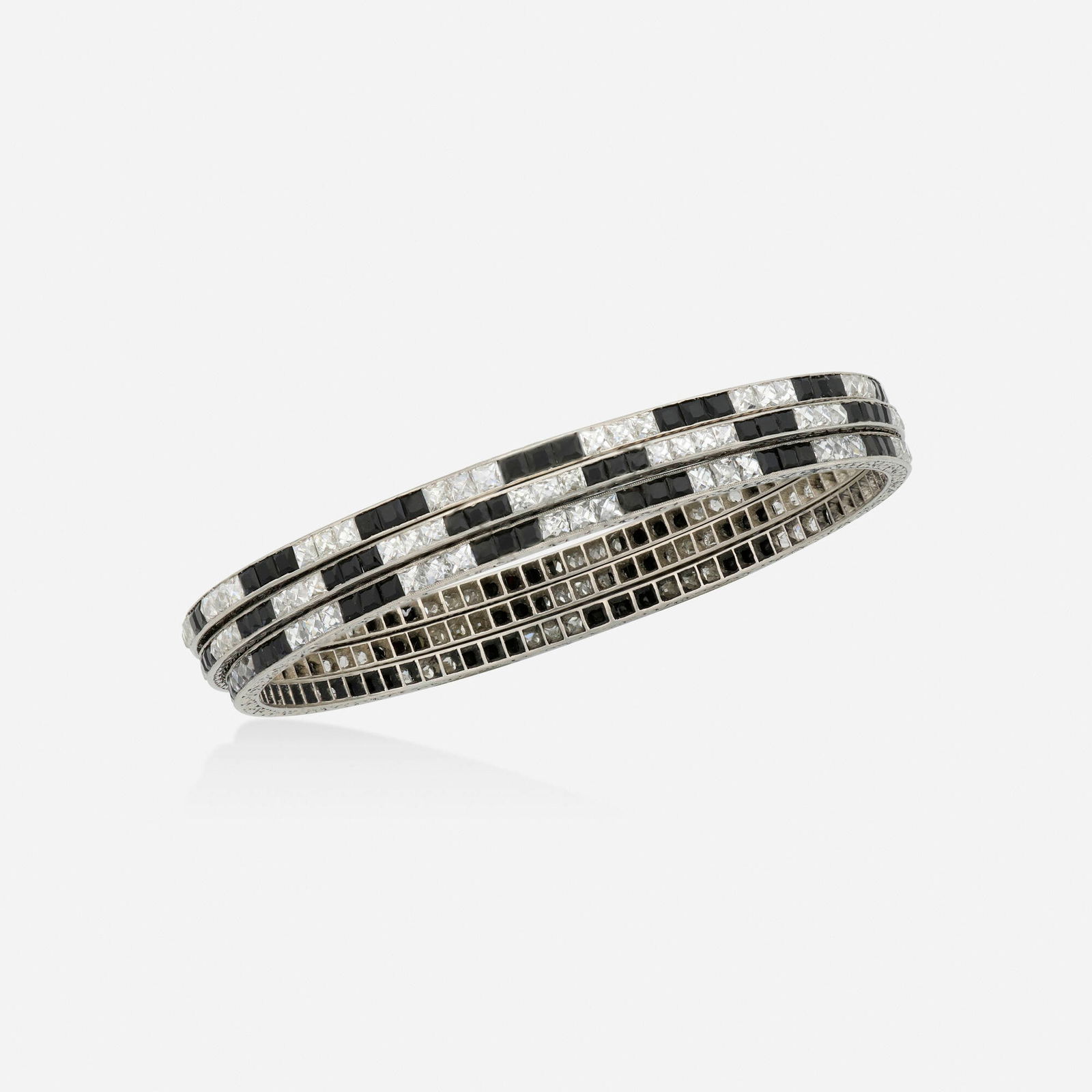 Art Deco, Three black onyx, diamond, and platinum bangle bracelets (1 of 3)