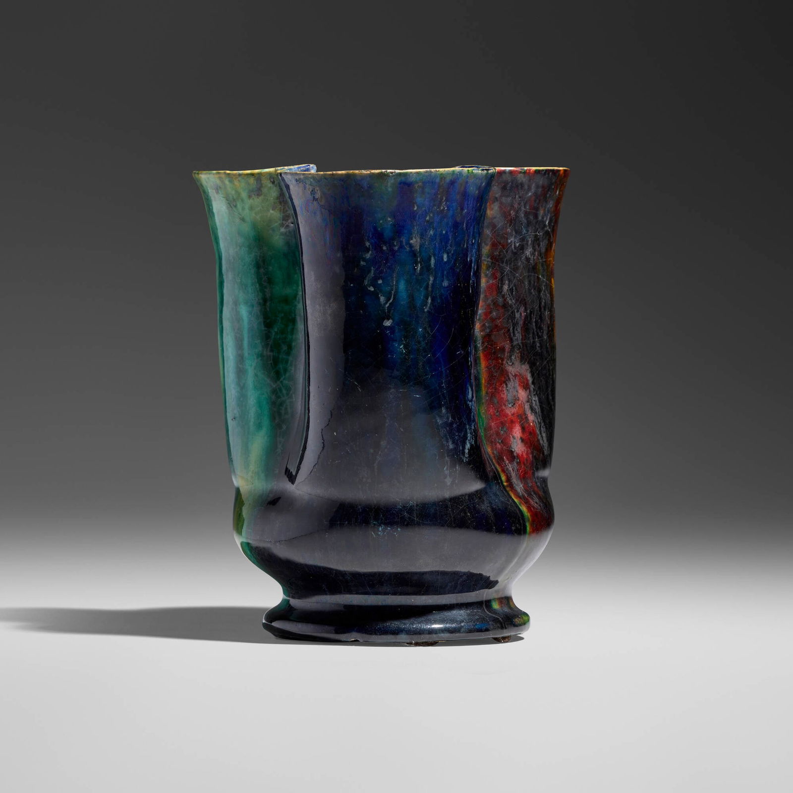 George E. Ohr, Vase: George E. Ohr Vase USA, 1897-1900 glazed earthenware 6 h x 5.25 w x 4.5 d in (15 x 13 x 11 cm) Vase features a trefoil lobed body and alternating indigo, emerald, raspberry, and gunmetal glazes.