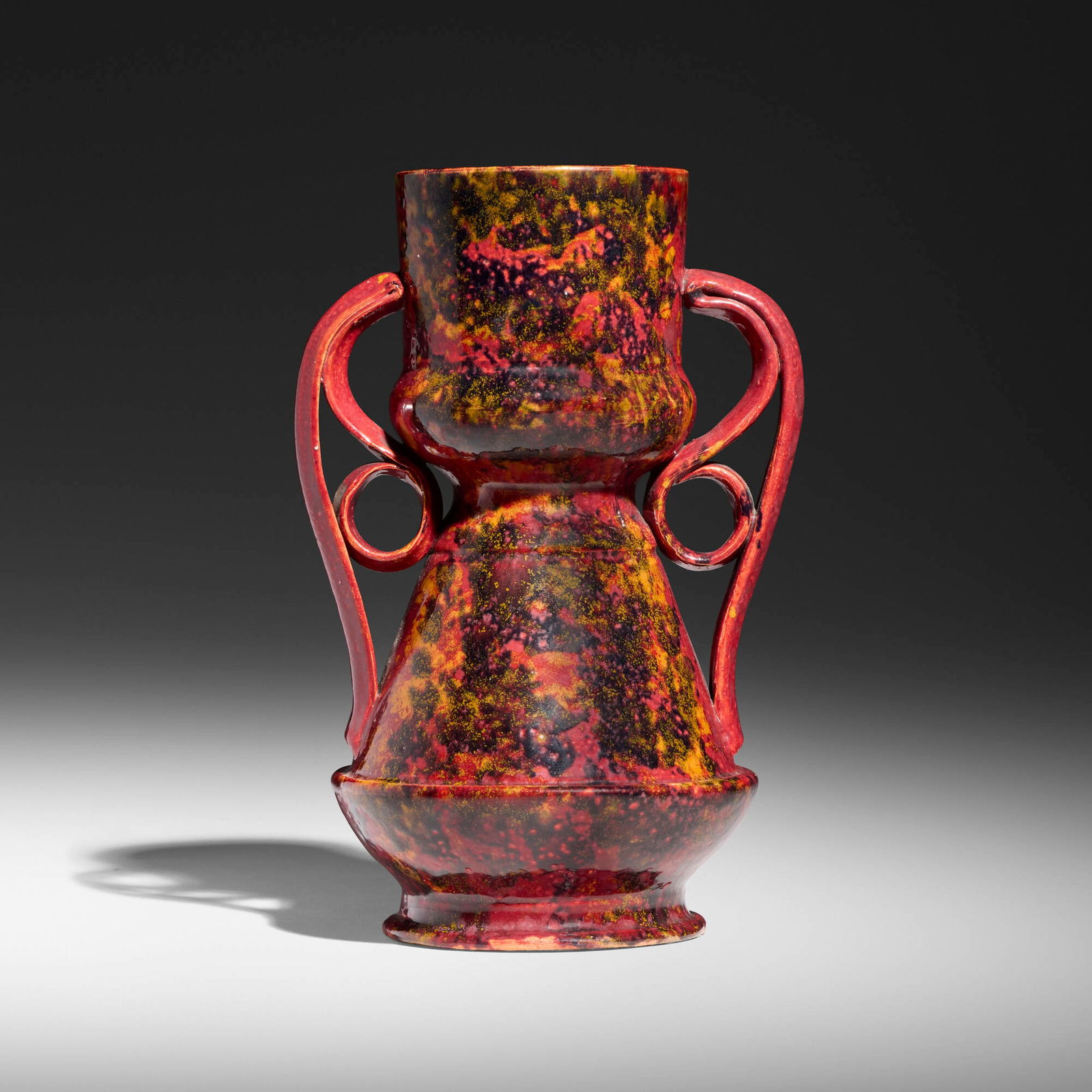 George E. Ohr, Vase: George E. Ohr Vase USA, 1898-1910 glazed earthenware 7.75 h x 5 w x 4 d in (20 x 13 x 10 cm) Vase features two ribbon handles and a raspberry glaze with sponged-on orange and indigo glazes.