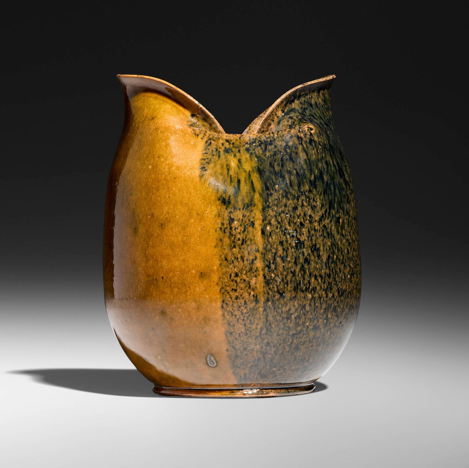 George E. Ohr, Vase: George E. Ohr Vase USA, 1897-1900 glazed earthenware 5.5 h x 4.25 dia in (14 x 11 cm) Vase features a pinched and lobed rim with a speckled indigo glaze to one side and ochre glaze to the other