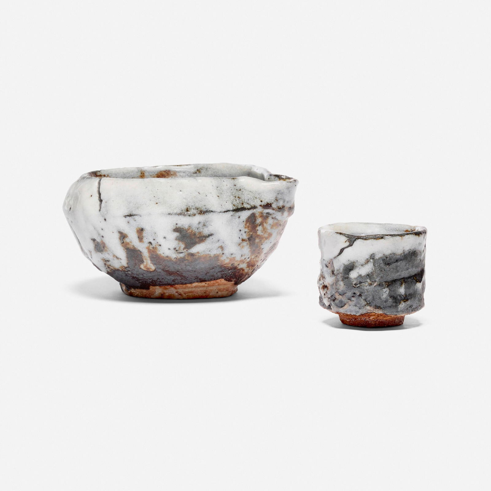 Shinji Suzuki, Anagama Yohen Nezumi Shino sake set: Shinji Suzuki Anagama Yohen Nezumi Shino sake set 2022glazed and anagama-fired stoneware 2.5 h x 5.25 w x 5 d in (6 x 13 x 13 cm) 2 h x 2.125 w x 2.125 d in (5 x 5 x 5 cm) Sold with origina