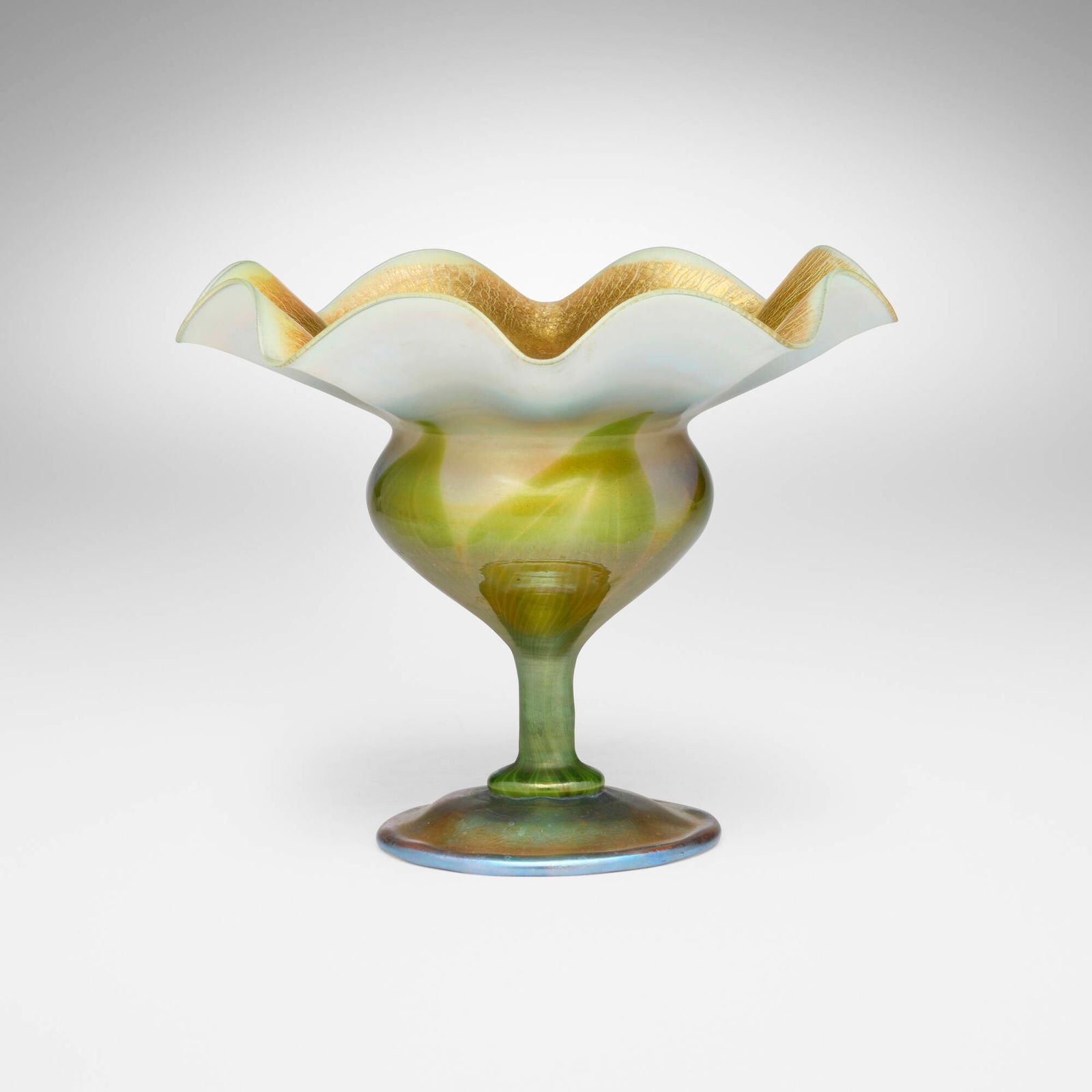 Tiffany Studios, Ruffled pulled-feather compote: Tiffany Studios Ruffled pulled-feather compote USA, c. 1904-06 hand-blown Favrile glass 6.875 h x 8.5 dia in (17 x 22 cm) Etched to underside '7085C L. C. Tiffany - Favrile'. Provenance: Philip