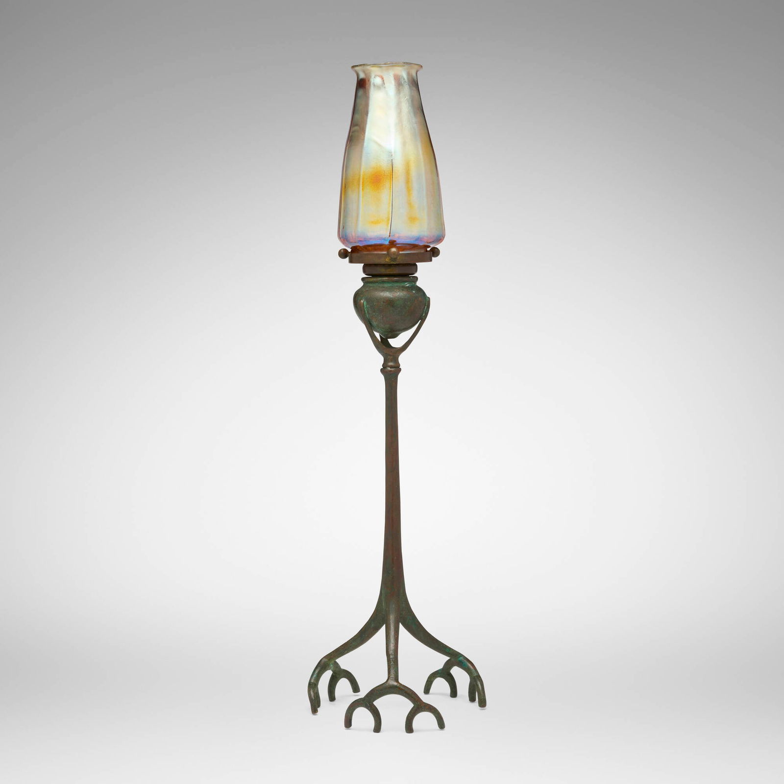 Tiffany Studios, Root candlestick with shade: Tiffany Studios Root candlestick with shade USA, c. 1910 patinated bronze, hand-blown Favrile glass 18.5 h x 5.25 dia in (47 x 13 cm) Etched to shade 'L.C.T.'. Impressed to base 'TIFFANY STUDIOS