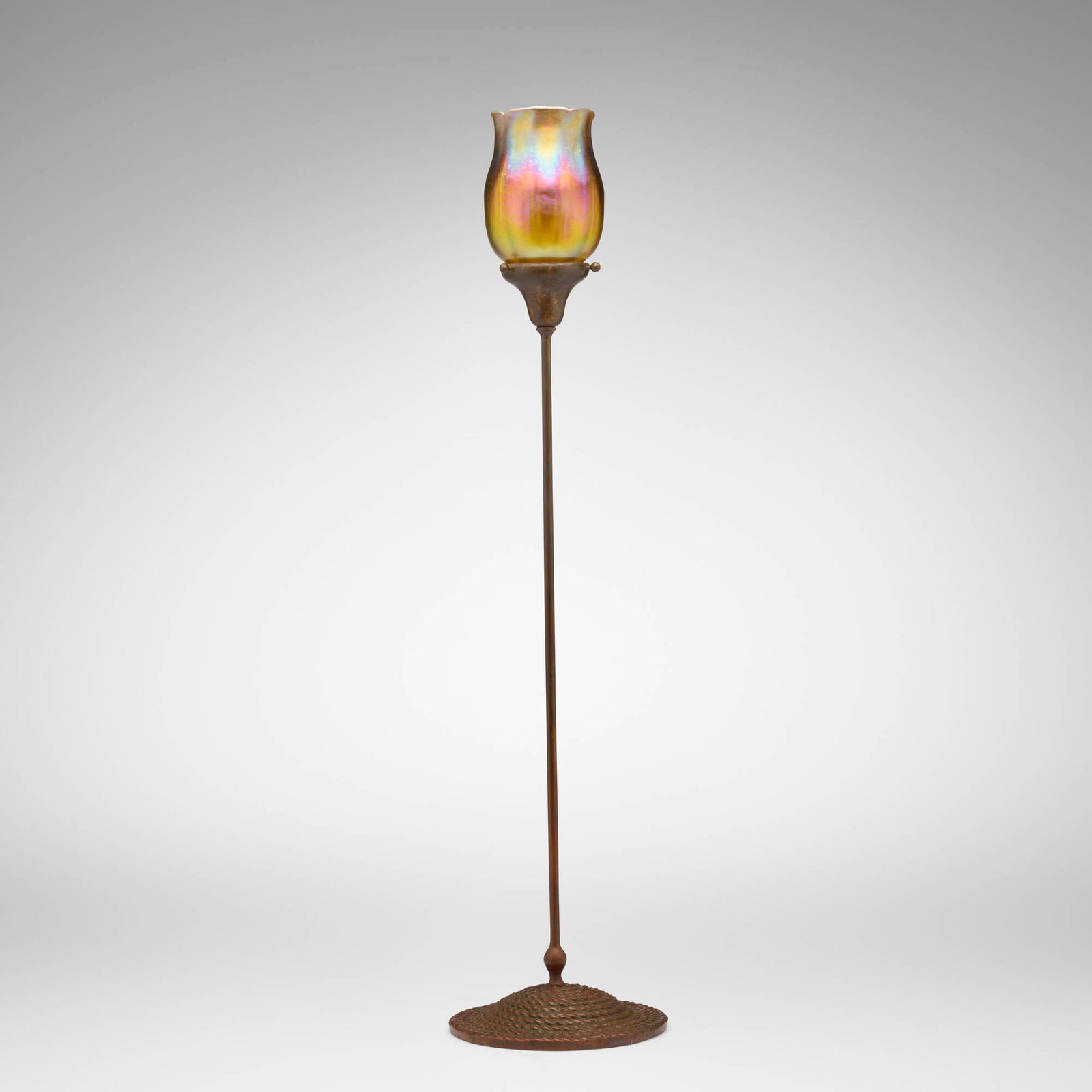 Tiffany Studios, Ribbed shade: Tiffany Studios Ribbed shade USA, c. 1910hand-blown Favrile glass, patinated metal 28 h x 6.75 dia in (71 x 17 cm) Etched to shade 'L.C.T.'. Sold with a period coiled rope candlestick base.