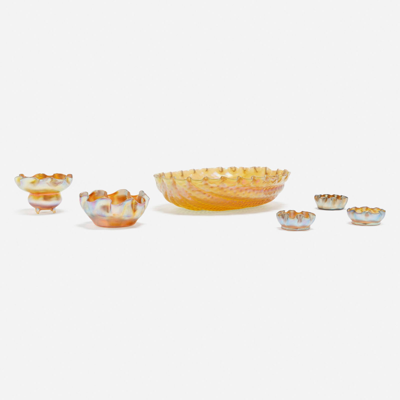 Tiffany Studios, Collection of five ruffled tablewares: Tiffany Studios Collection of five ruffled tablewares USA, c. 1900 hand-blown Favrile glass largest: 2.5 h x 11.75 w x 9.5 d in (6 x 30 x 24 cm) smallest: 1 h x 2.5 dia in (3 x 6 cm) Collection is