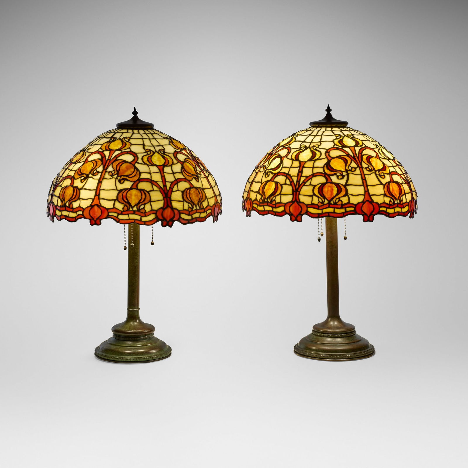 Unique Art Glass & Metal Company, Pomegranate table lamps, pair: Unique Art Glass & Metal Company Pomegranate table lamps, pair USA, c. 1905 leaded slag glass, patinated metal 25.75 h x 18.5 dia in (65 x 47 cm) Lamps each features a Russian base. Impressed