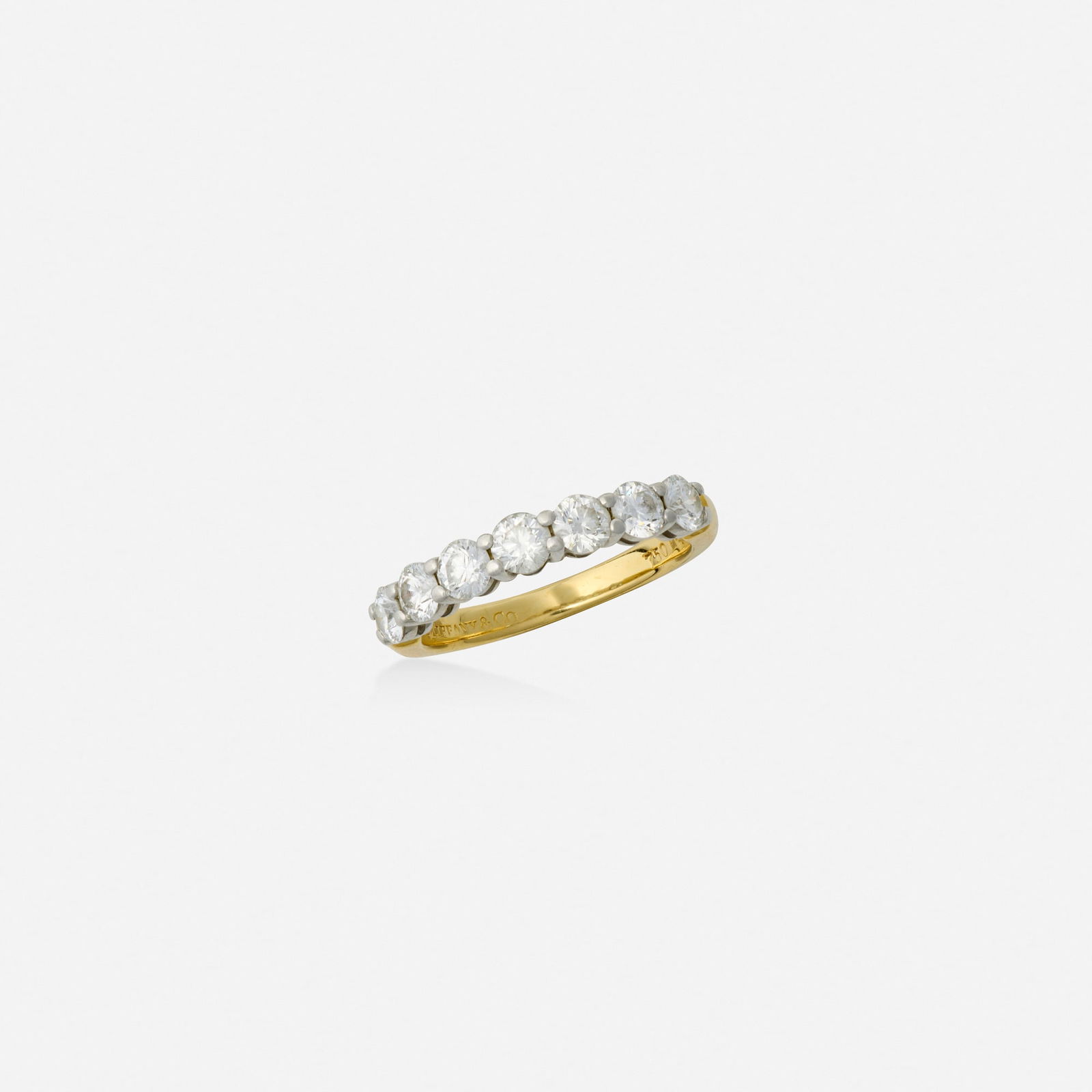 Tiffany & Co., Diamond, gold, and platinum ring: Tiffany & Co. Diamond, gold, and platinum ring Set with round brilliant-cut diamonds 18k yellow gold and platinum Signed Tiffany & Co. Ring size 5; Gross weight 2.4 dwts This work will ship from