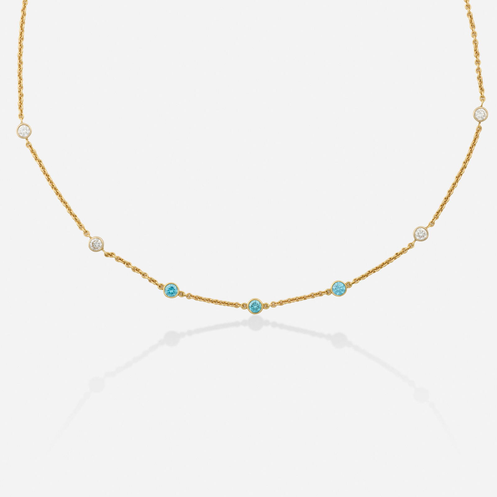 Diamond and gold necklace: Diamond and gold necklace Bezel-set with blue and near colorless round brilliant-cut diamonds 14k yellow gold 17 in, 16 in; Gross weight 4.4 dwts This work will ship from Lambertville, New Jersey.