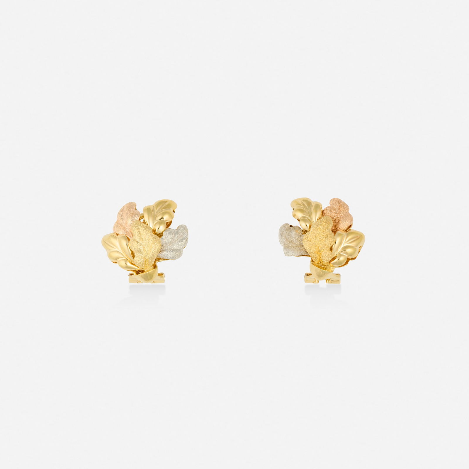 Italian, Tricolor gold earrings: Italian Tricolor gold earrings Of foliate design 18k yellow gold 0.75 x 0.625 in; Gross weight 7.2 dwts This work will ship from Lambertville, New Jersey.