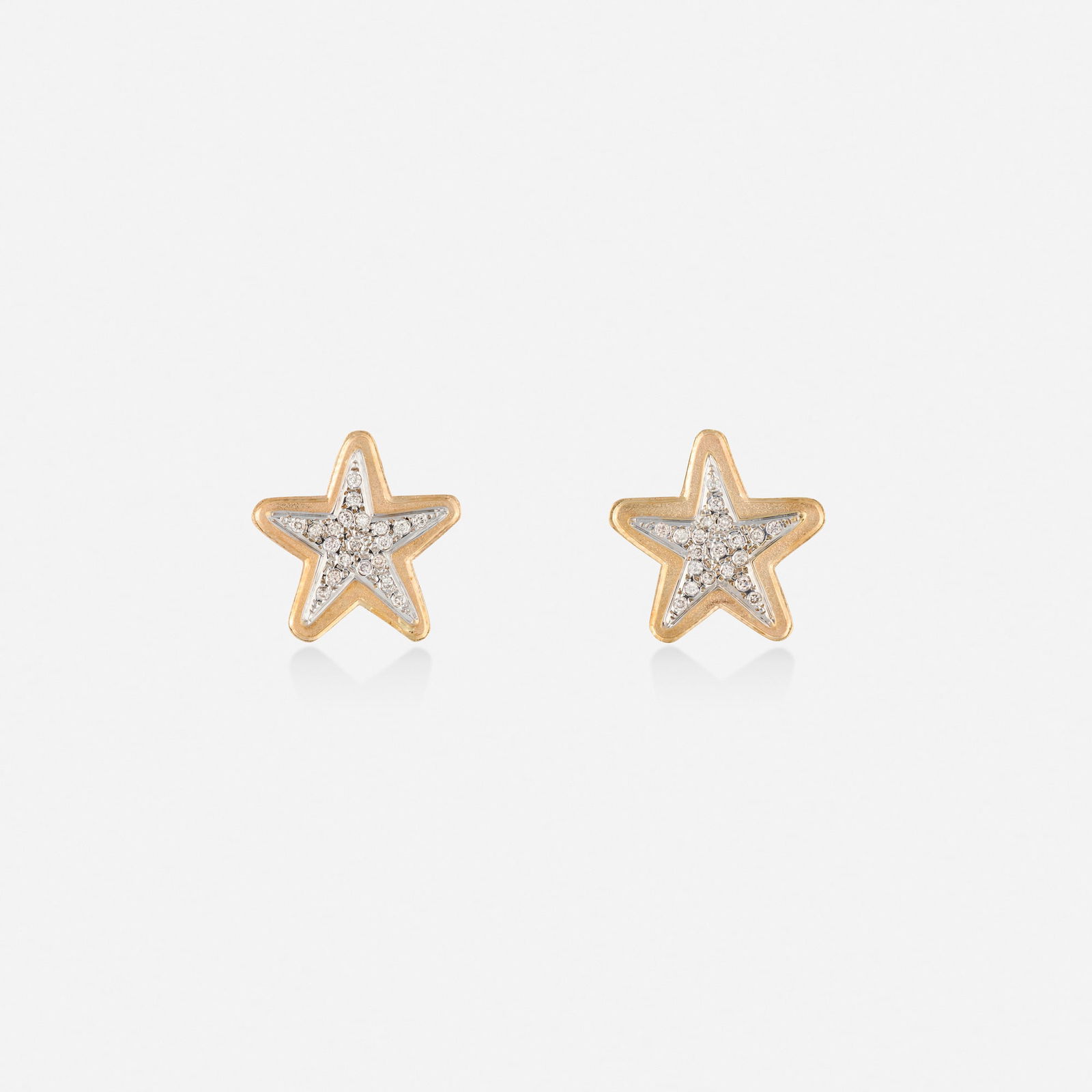 Diamond and bicolor gold earrings: Diamond and bicolor gold earrings Each a star set with round brilliant-cut diamonds 14k yellow and white gold 0.75 x 0.75 in; Gross weight 2.2 dwts This work will ship from Lambertville, New